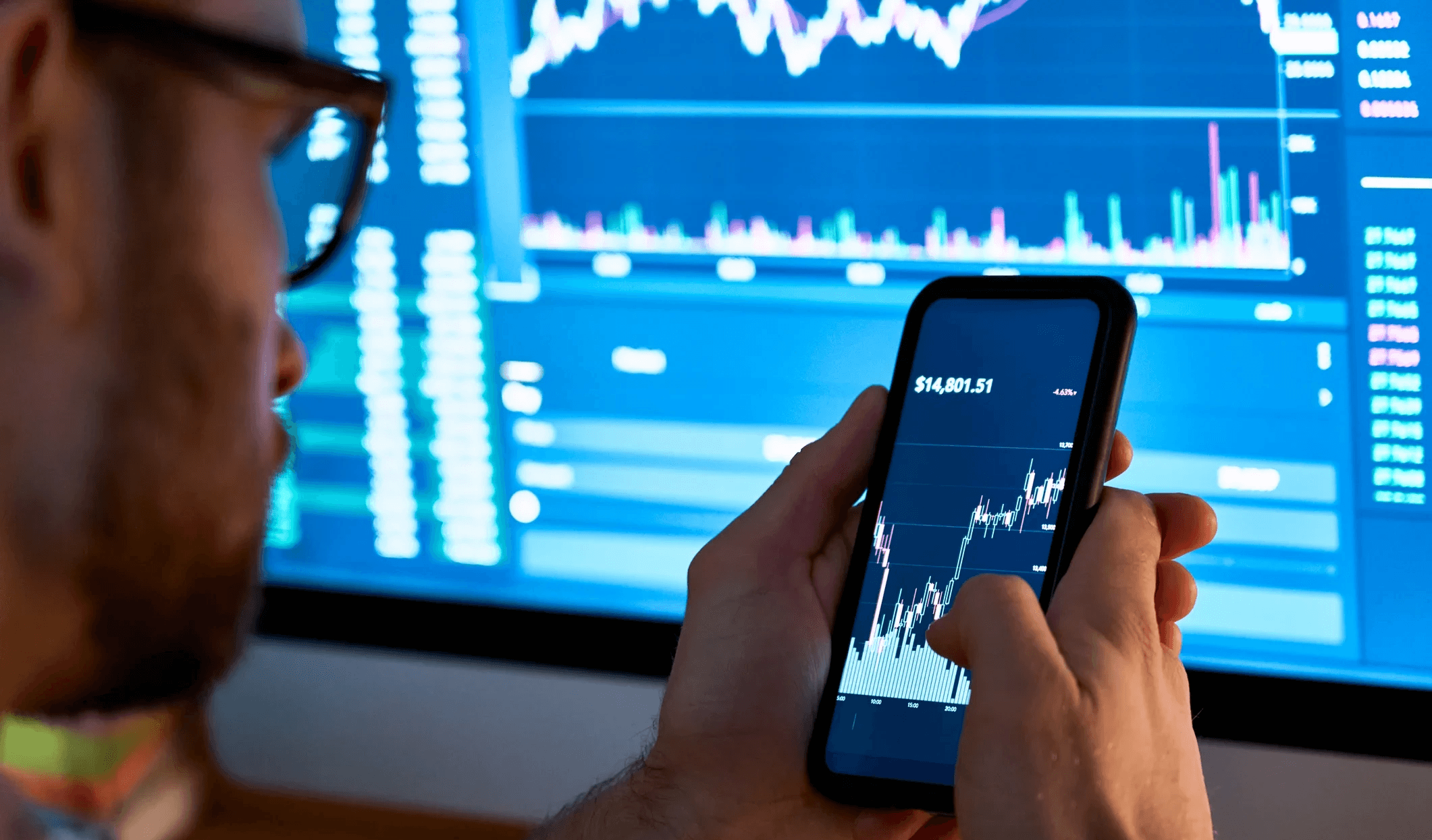 Man analyzing financial charts on smartphone - Is ICP Crypto a Good Investment