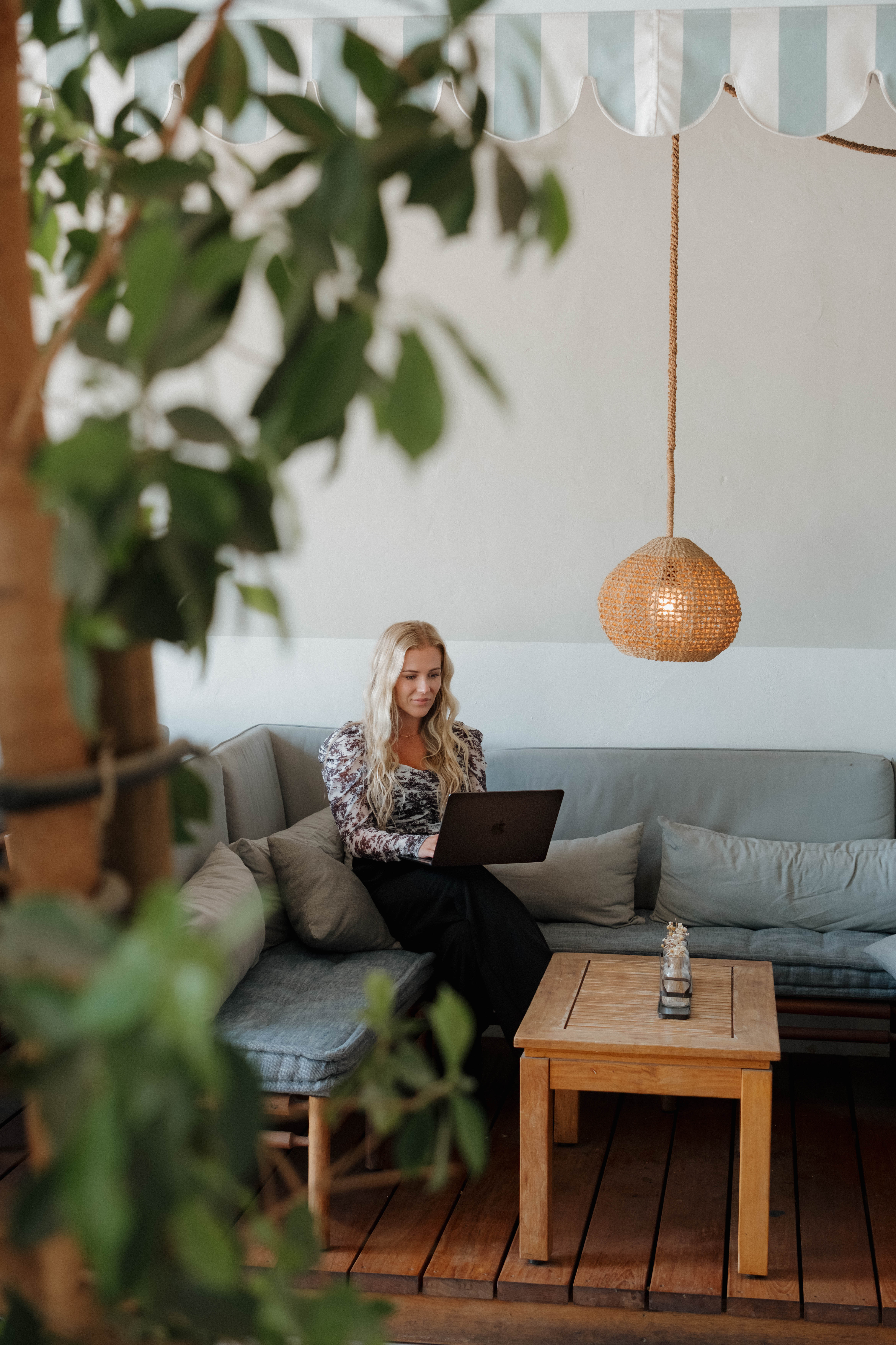 Smiling bearded man in a white t-shirt, standing outdoors by a lake with trees in the background in Gilbert, Arizona during branding photoshoot.
