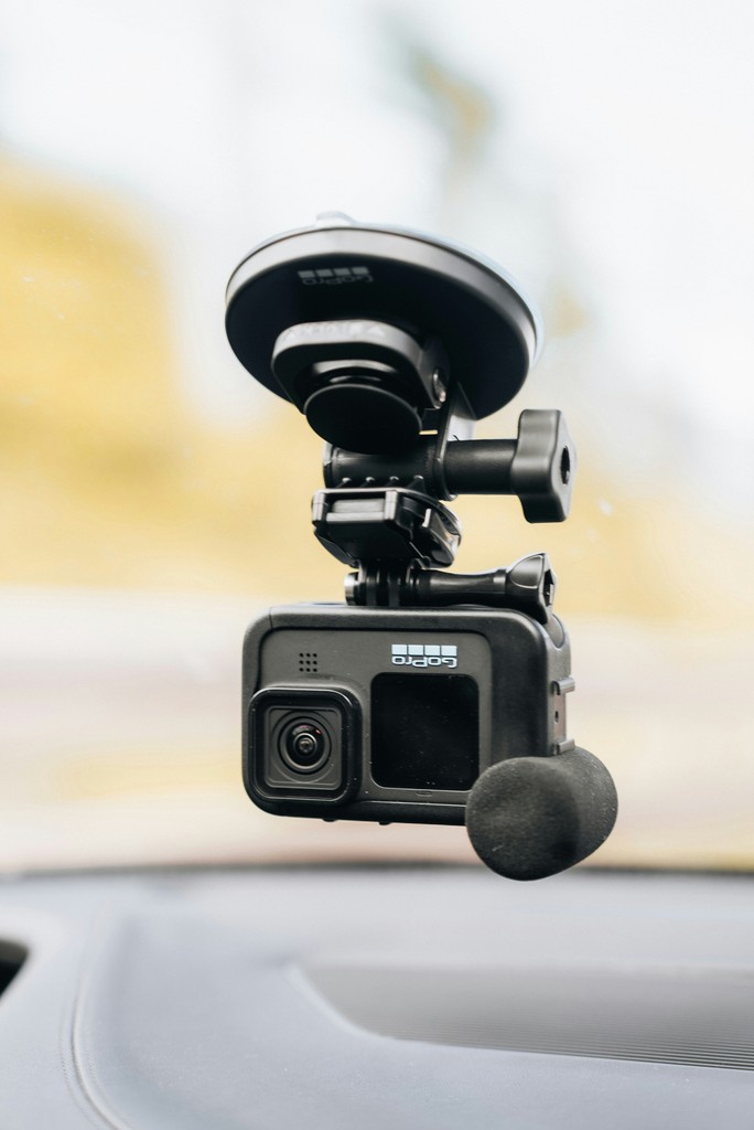 a car dashboard with a dash camera attached to it