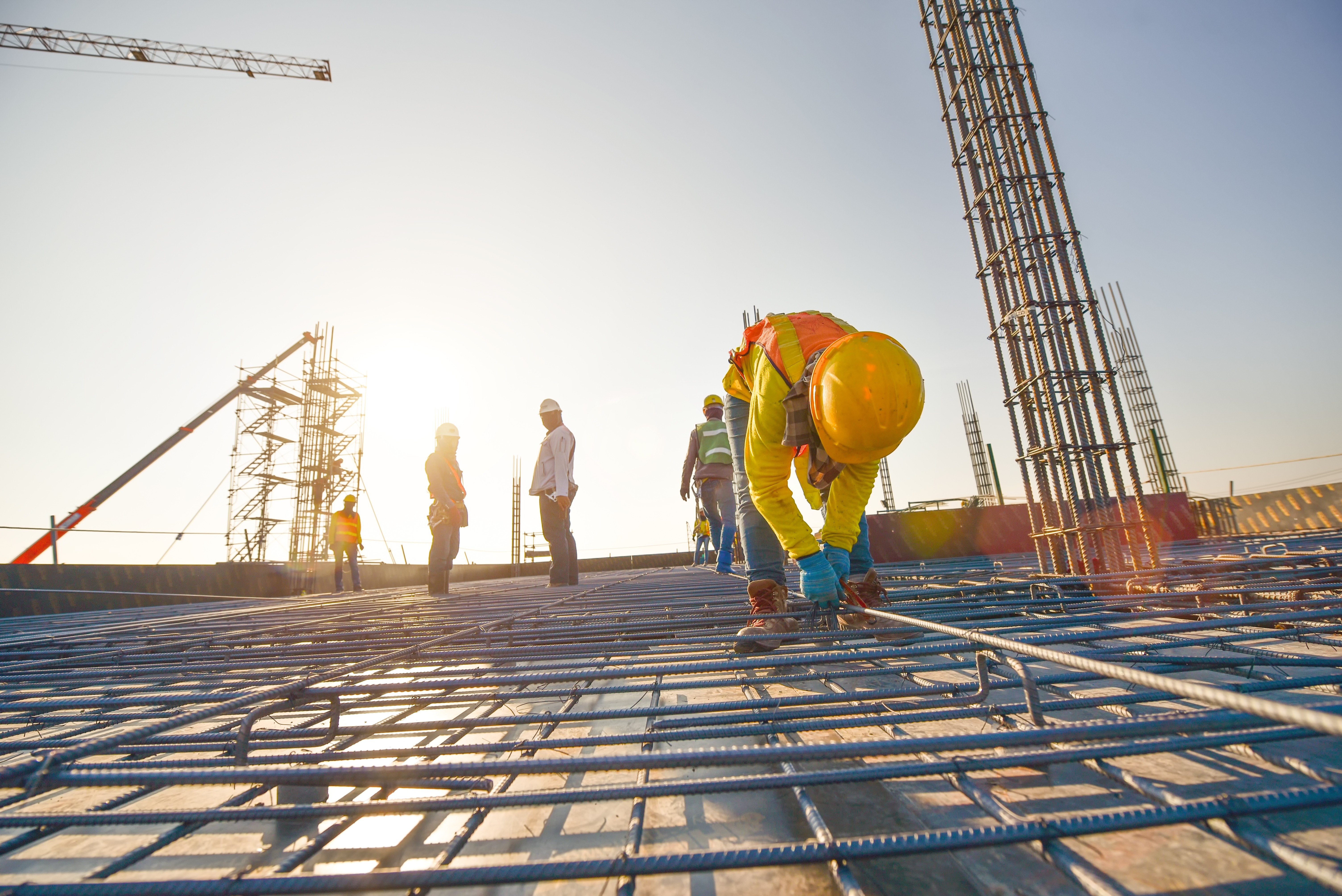 Construction workers fabricating steel reinforcement bar at the construction site by Automech