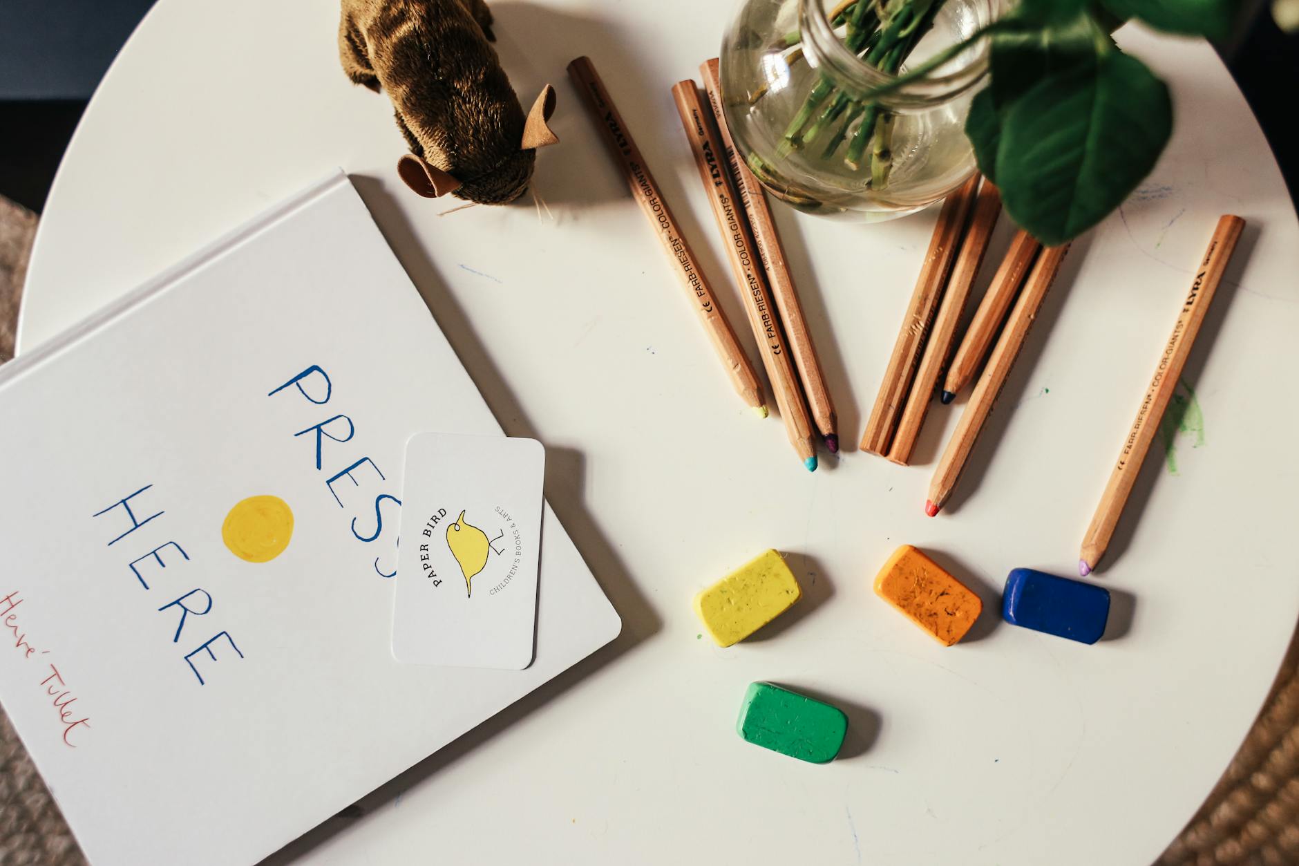 A cluttered desk with a red pen resting on a confusing, overly complex worksheet full of dense text.