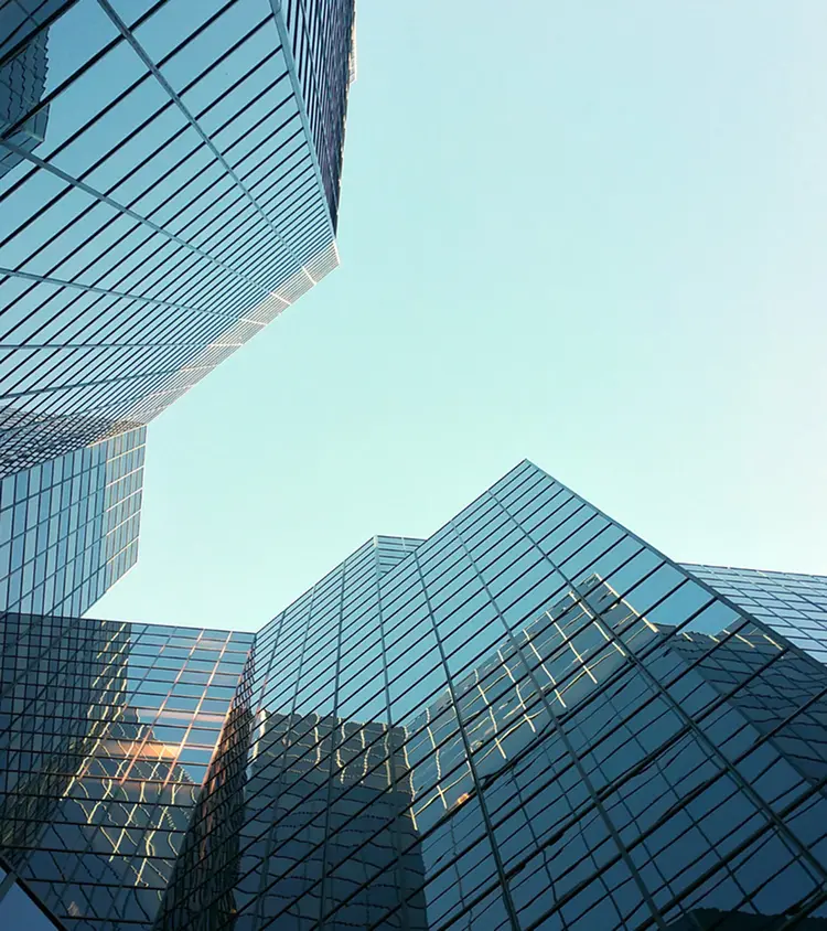a tall building with many windows and a sky background