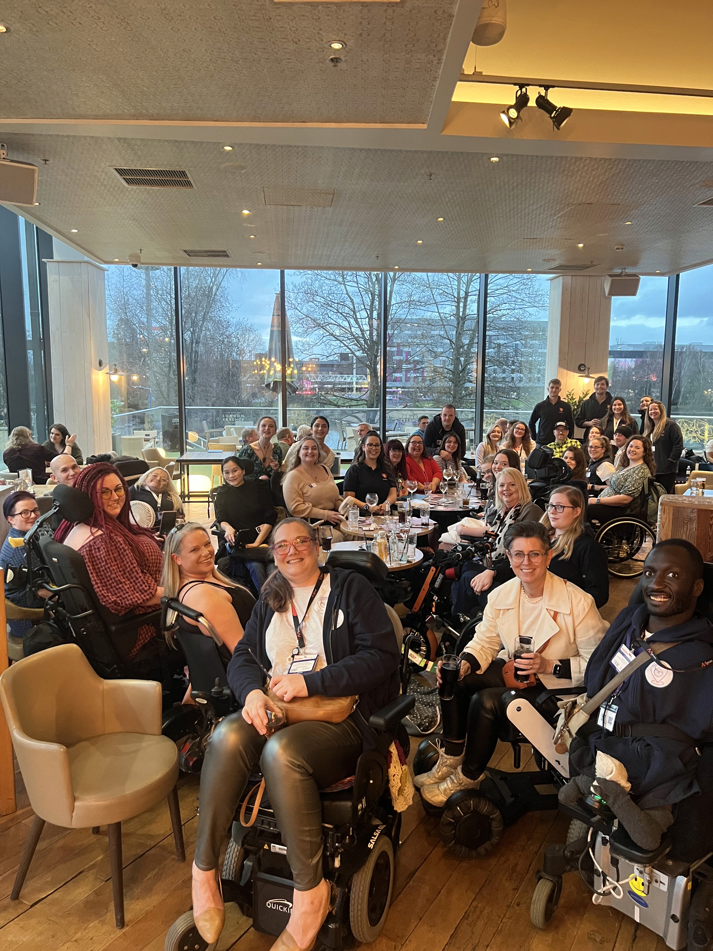 Approx 30 people including many wheelchair users posing for a group photo.