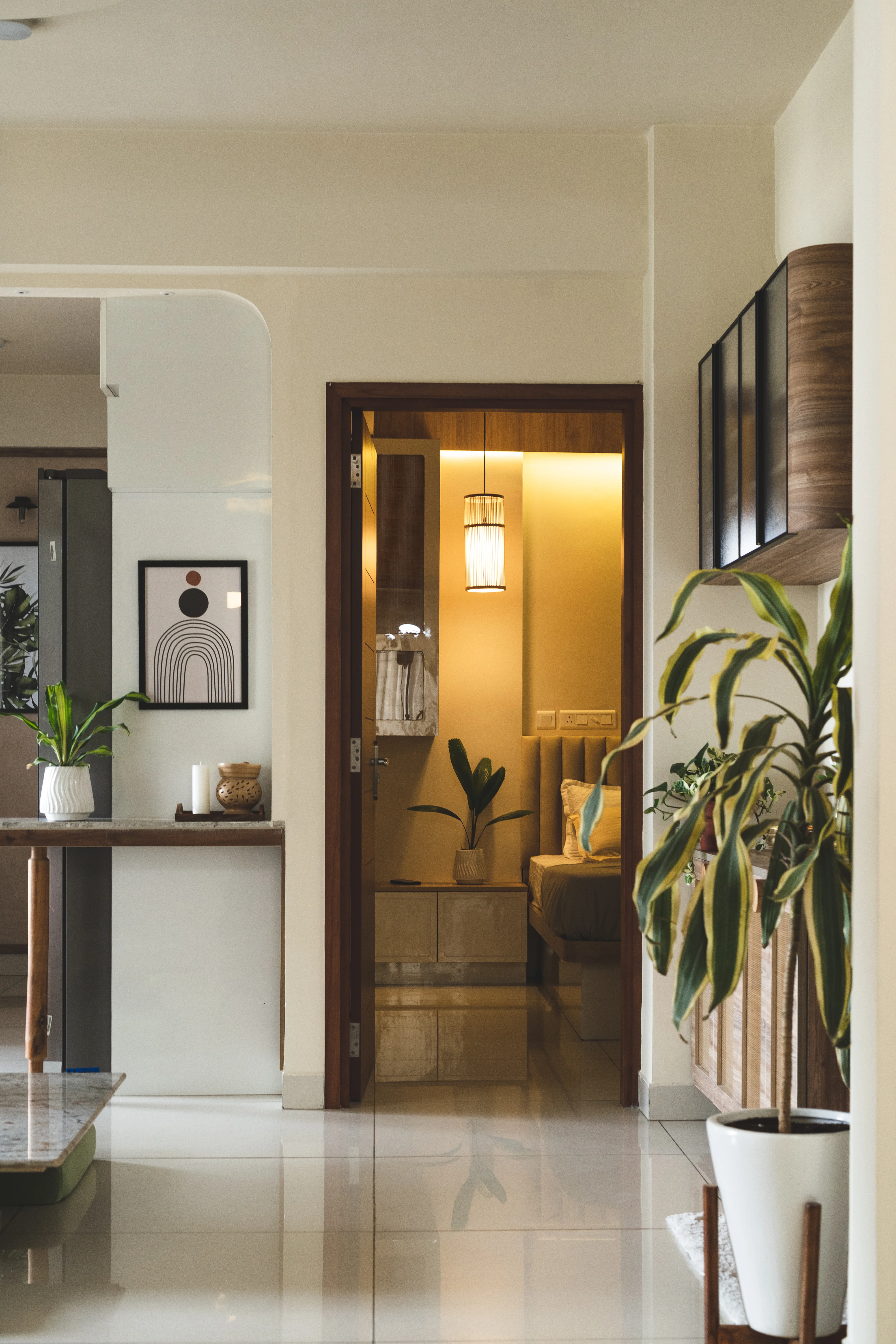 A modern South Indian home featuring a stylish living room and kitchen with curved, minimalistic design elements.
