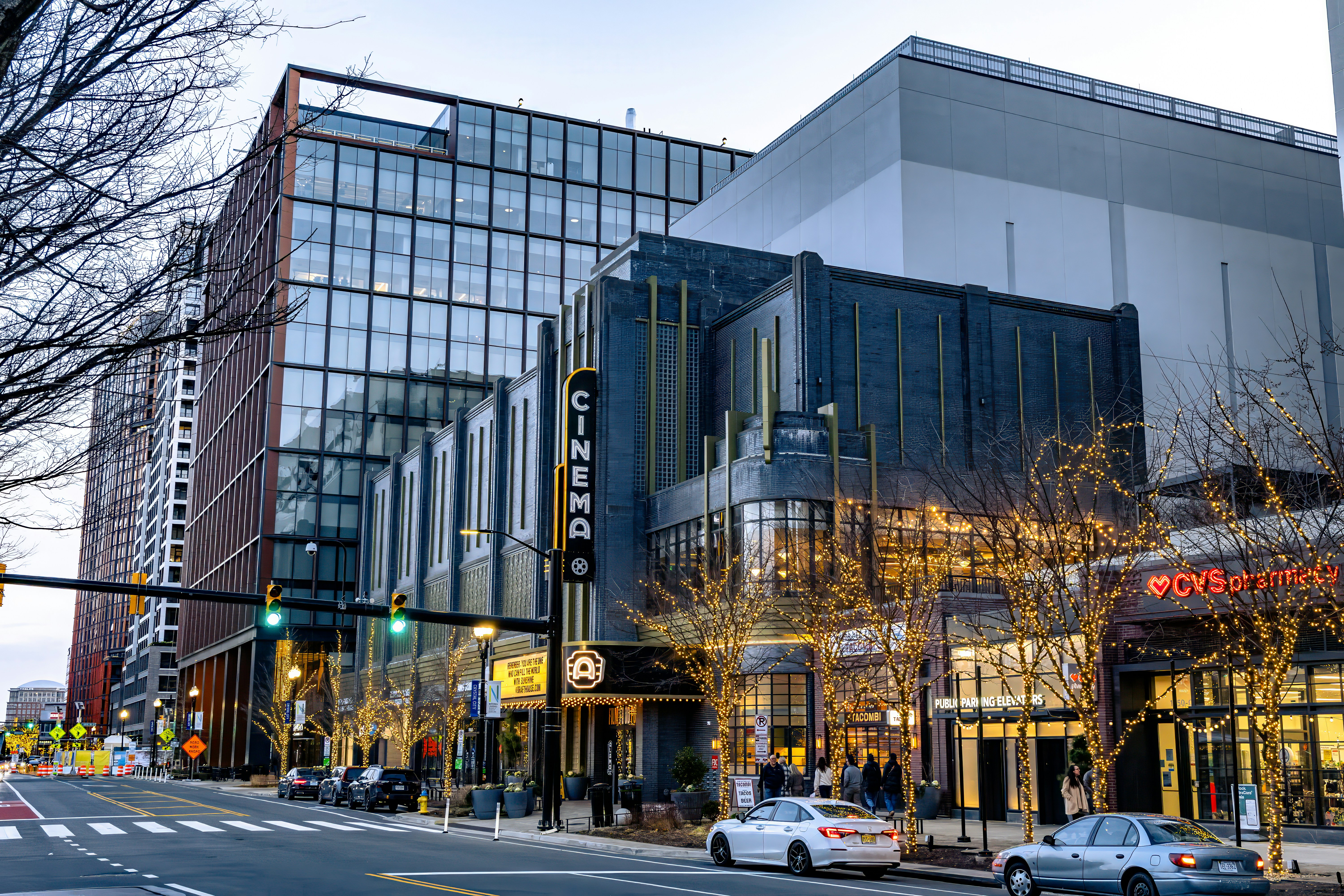 Modern buildings and streetlights on a city street.