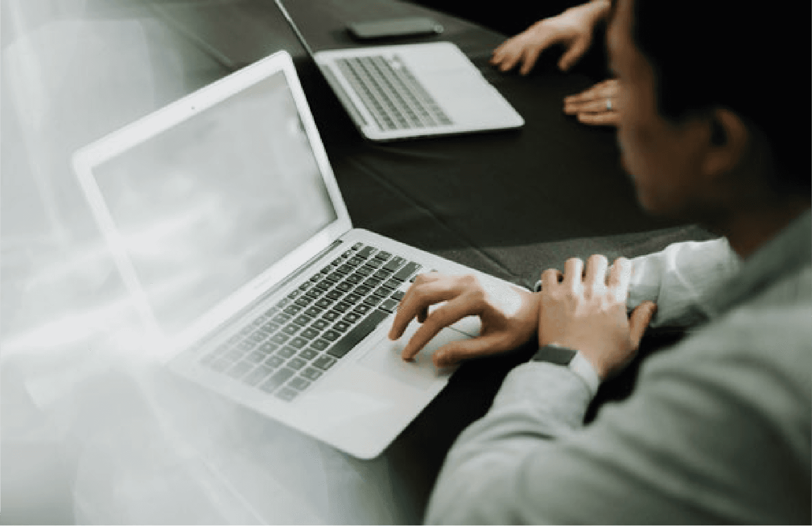 man's hand using a laptop