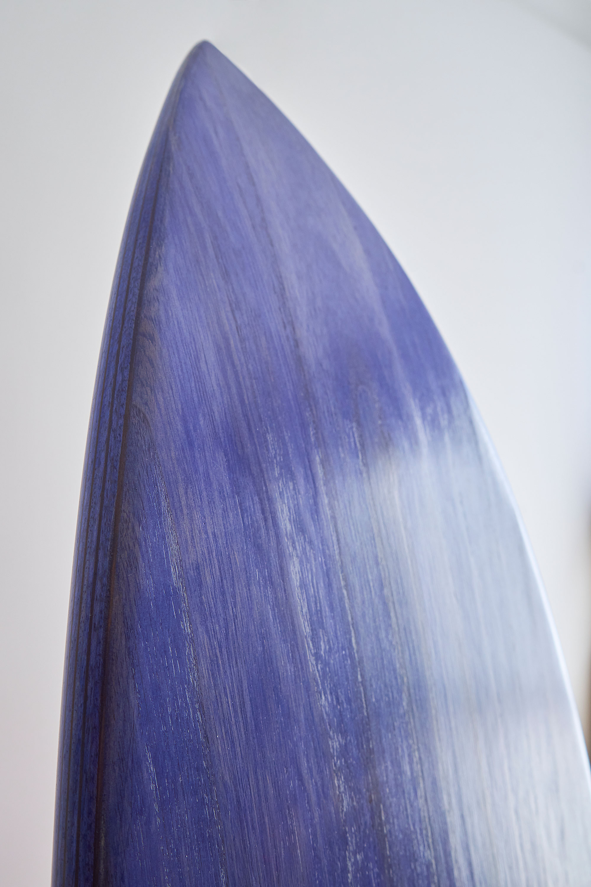 Wooden surfboard in purple stain
