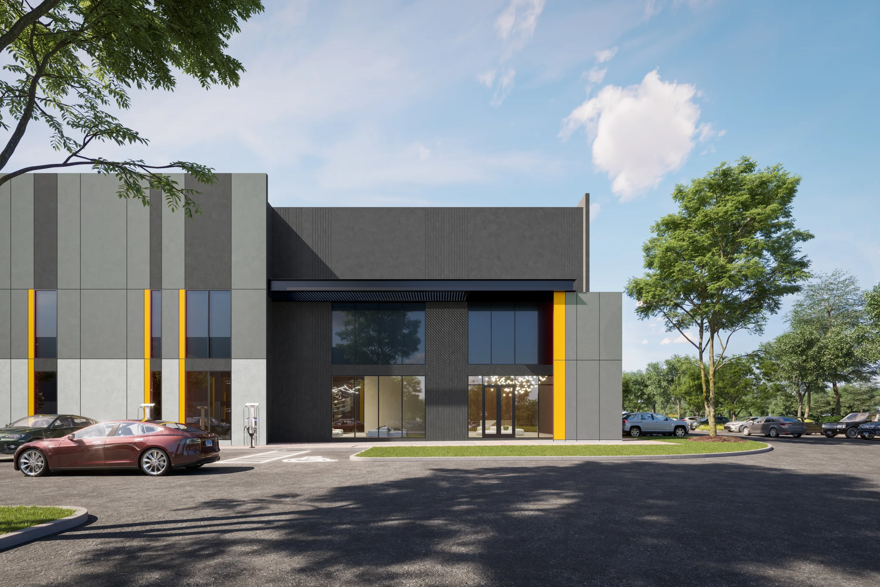 Exterior rendering of a modern single-story commercial/industrial building with gray panel siding accented by vertical yellow-orange stripes and large tinted glass storefront windows and doors. Cars are parked in front, including a red sedan near an EV charging station, with landscaped greenery, trees, and a paved driveway surrounding the building under a partly cloudy sky.