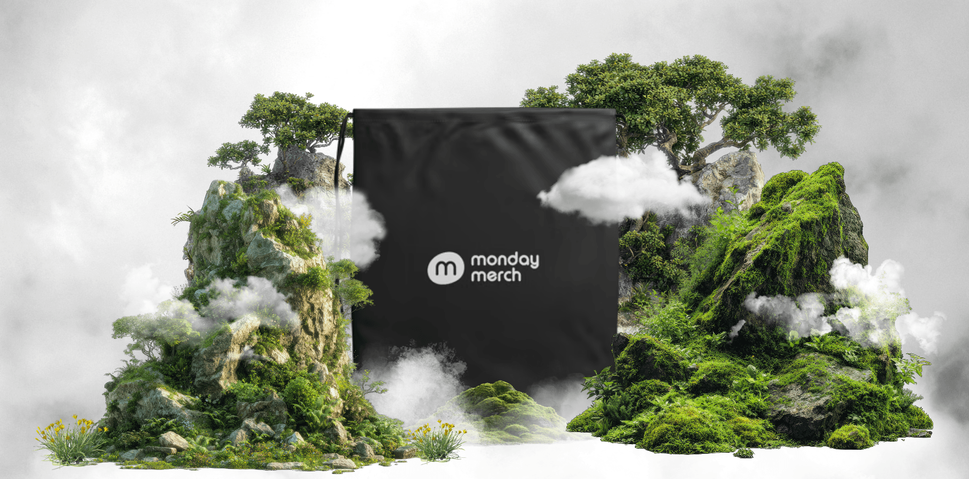 Monday Merch branded black bag surrounded by green mountains and mist
