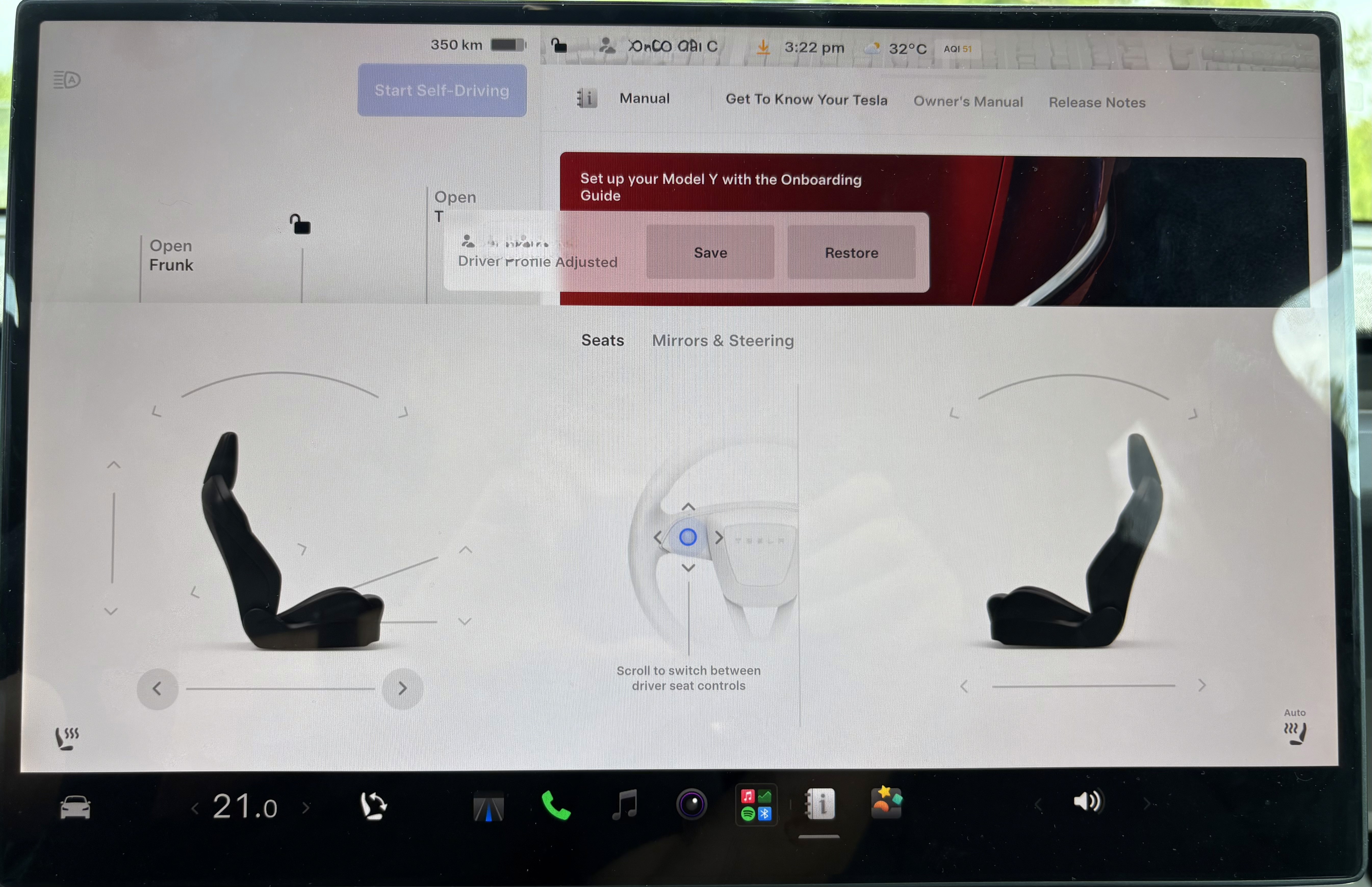 The image shows the infotainment screen of a Tesla Model Y vehicle, displaying a seat adjustment interface with options for adjusting the driver's and passenger's seat positions, surrounded by icons for climate control and other vehicle settings.
