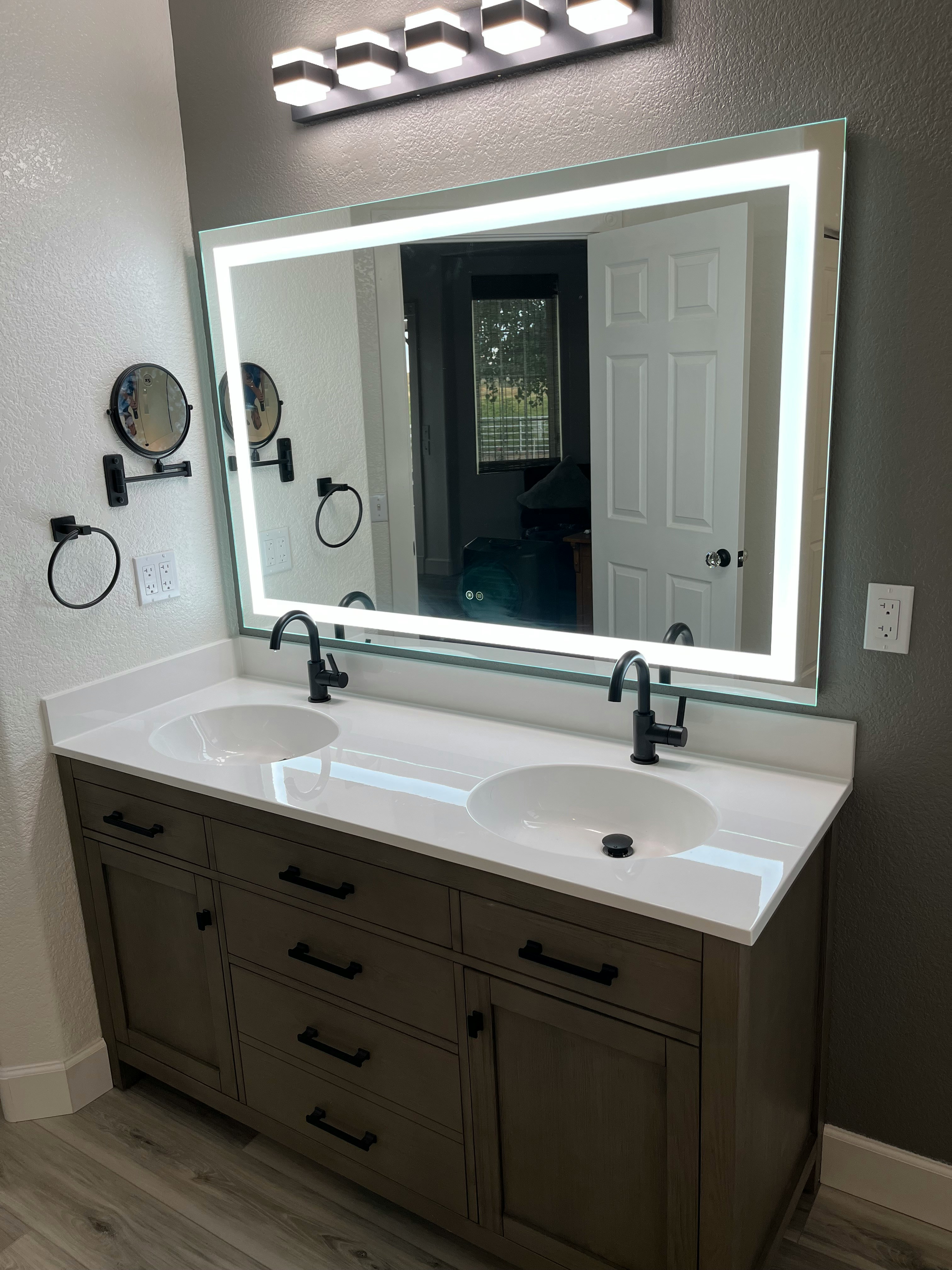 a bathroom with two sinks and a large mirror