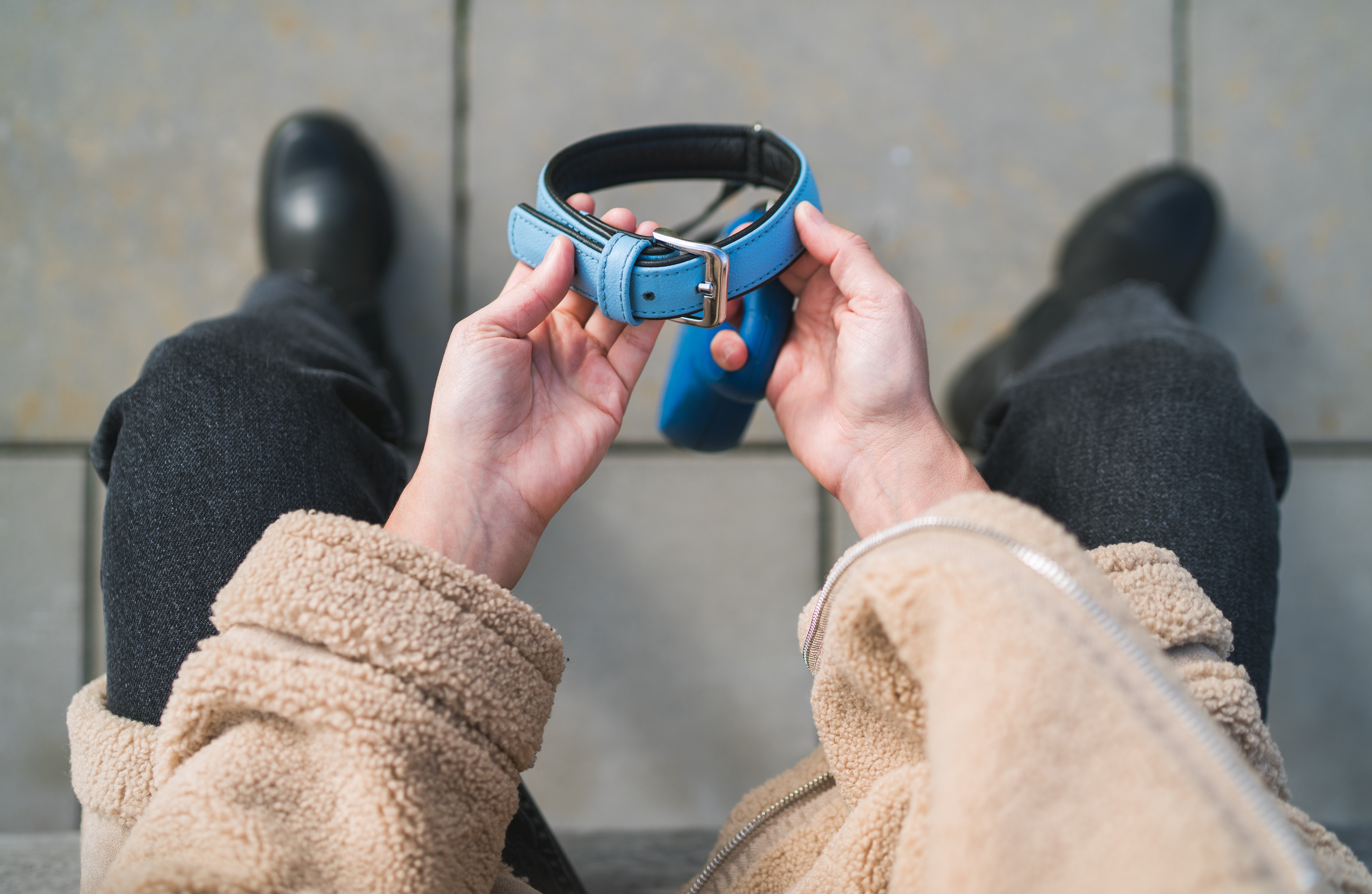 A man holding his pet’s collar thinking how to store pet’s memories in the right way by ARENA Storage