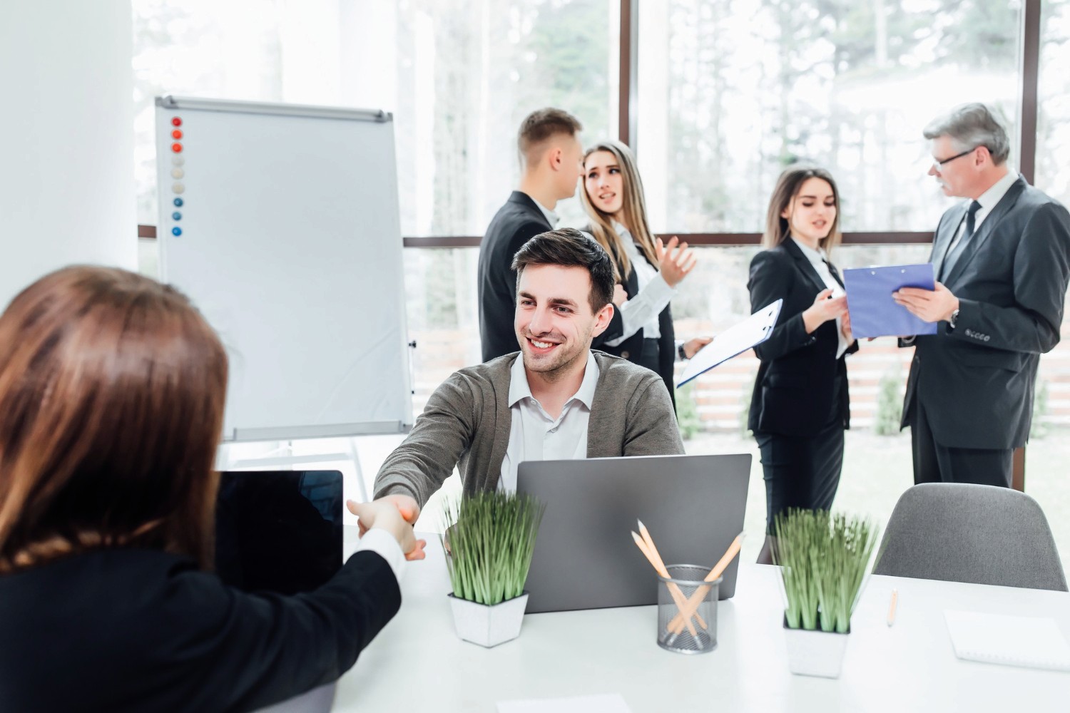 Group of businessmen discussing  and making a deal about their RAKEZ company formation.