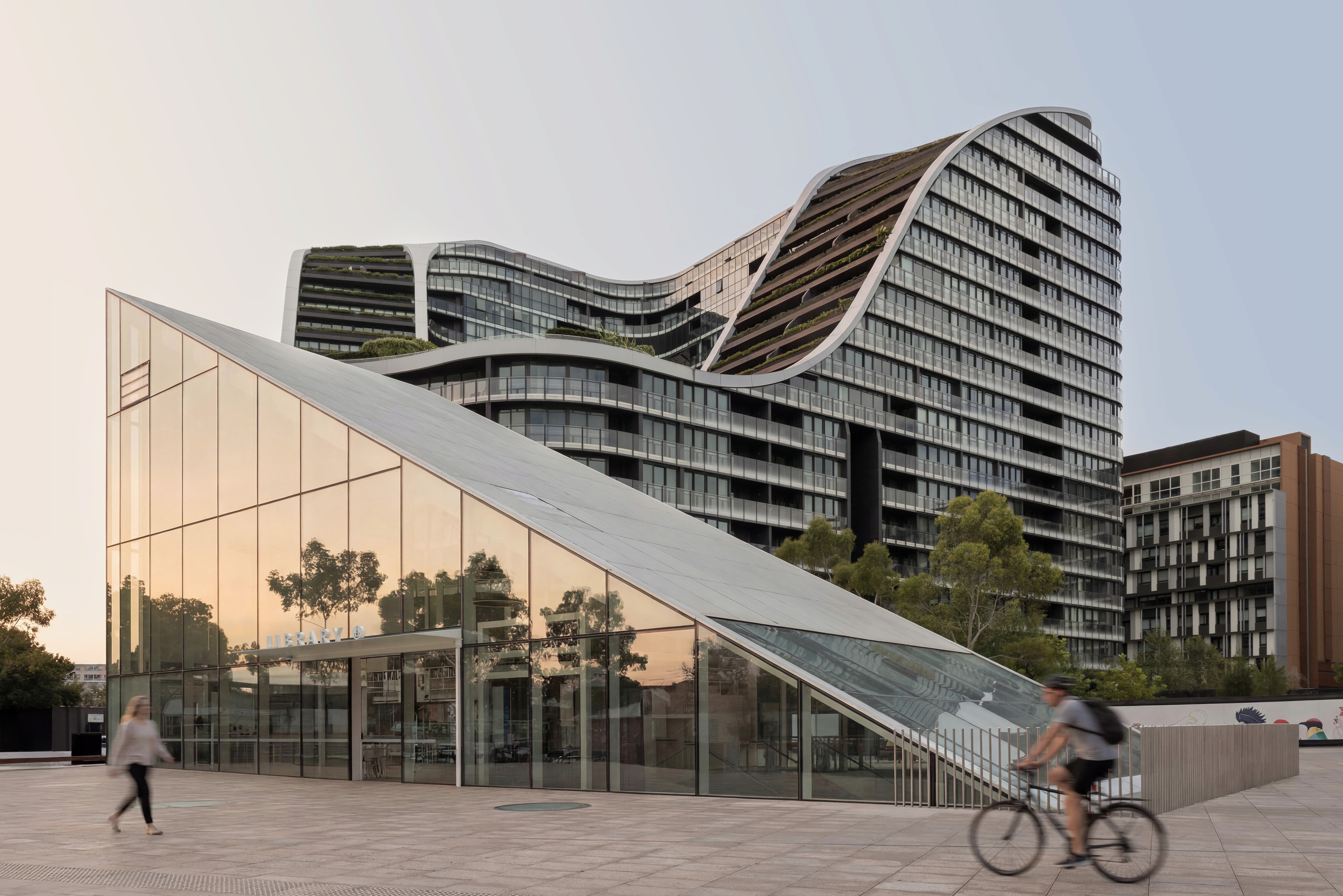Exterior view of Green Square Library, a contemporary civic structure in Sydney, set within an active urban plaza.