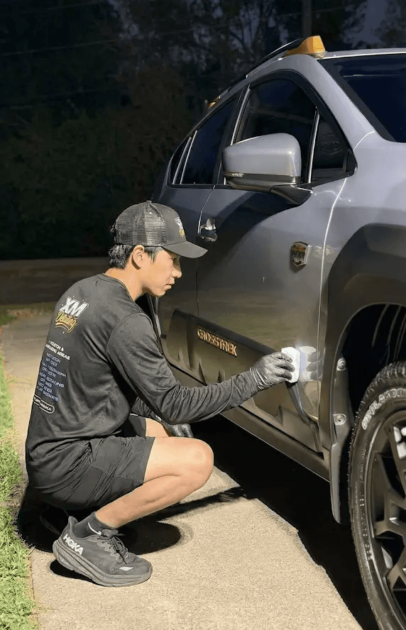 Professional mobile car detailing in Houston featuring a lime green Lamborghini Revuelto with a ceramic coating finish parked outside a detailing studio.