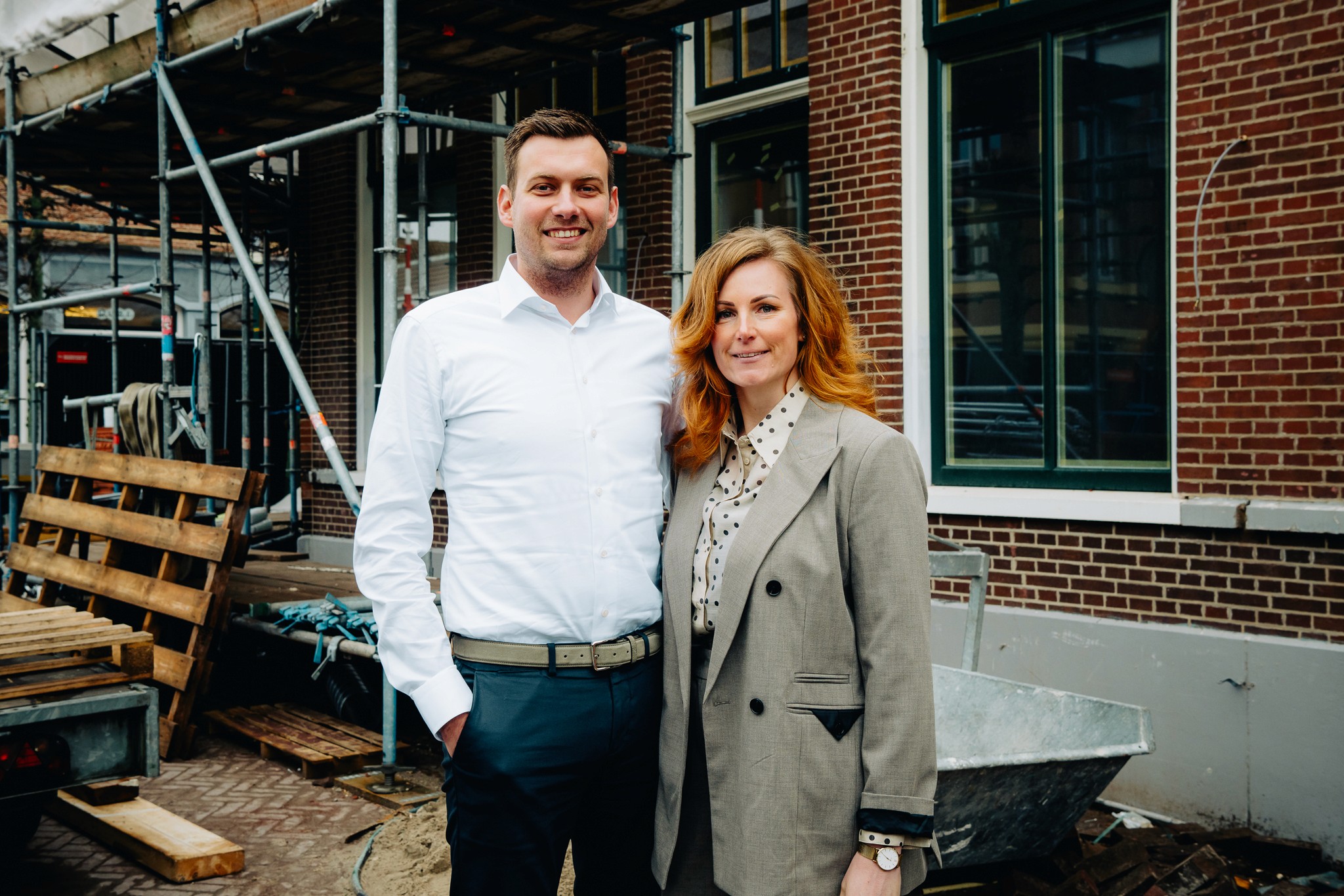Restaurant bar with guests seated at tables and bartenders at work.