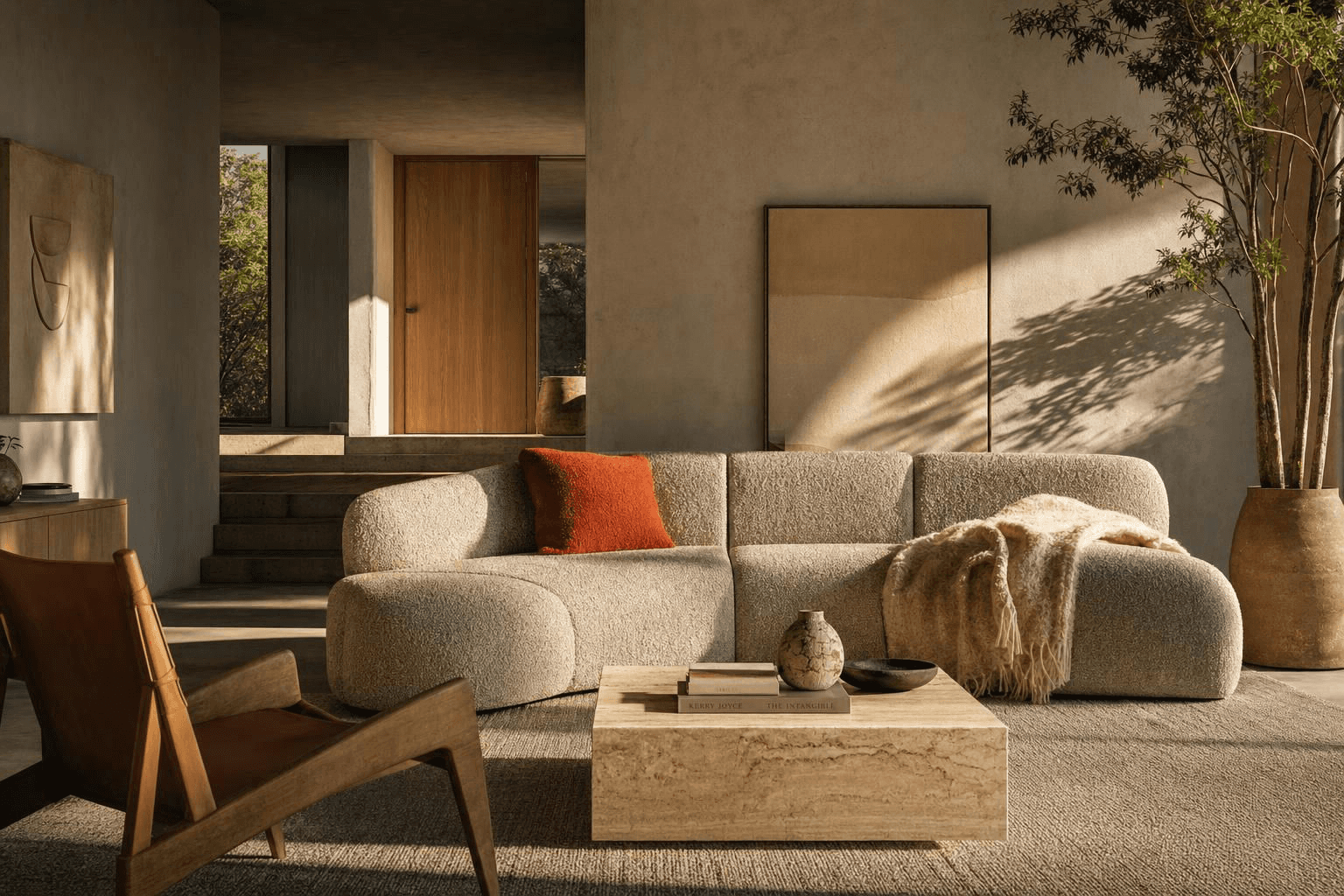Living room with a textured beige sectional sofa, rust pillow, tan throw, stone coffee table, wooden chair, large potted tree, and neutral wall art.