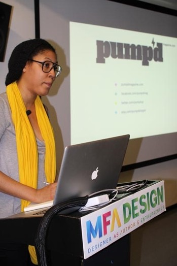 A photo of a woman giving a lecture from a laptop while on the screen projector there is the word pump'd.