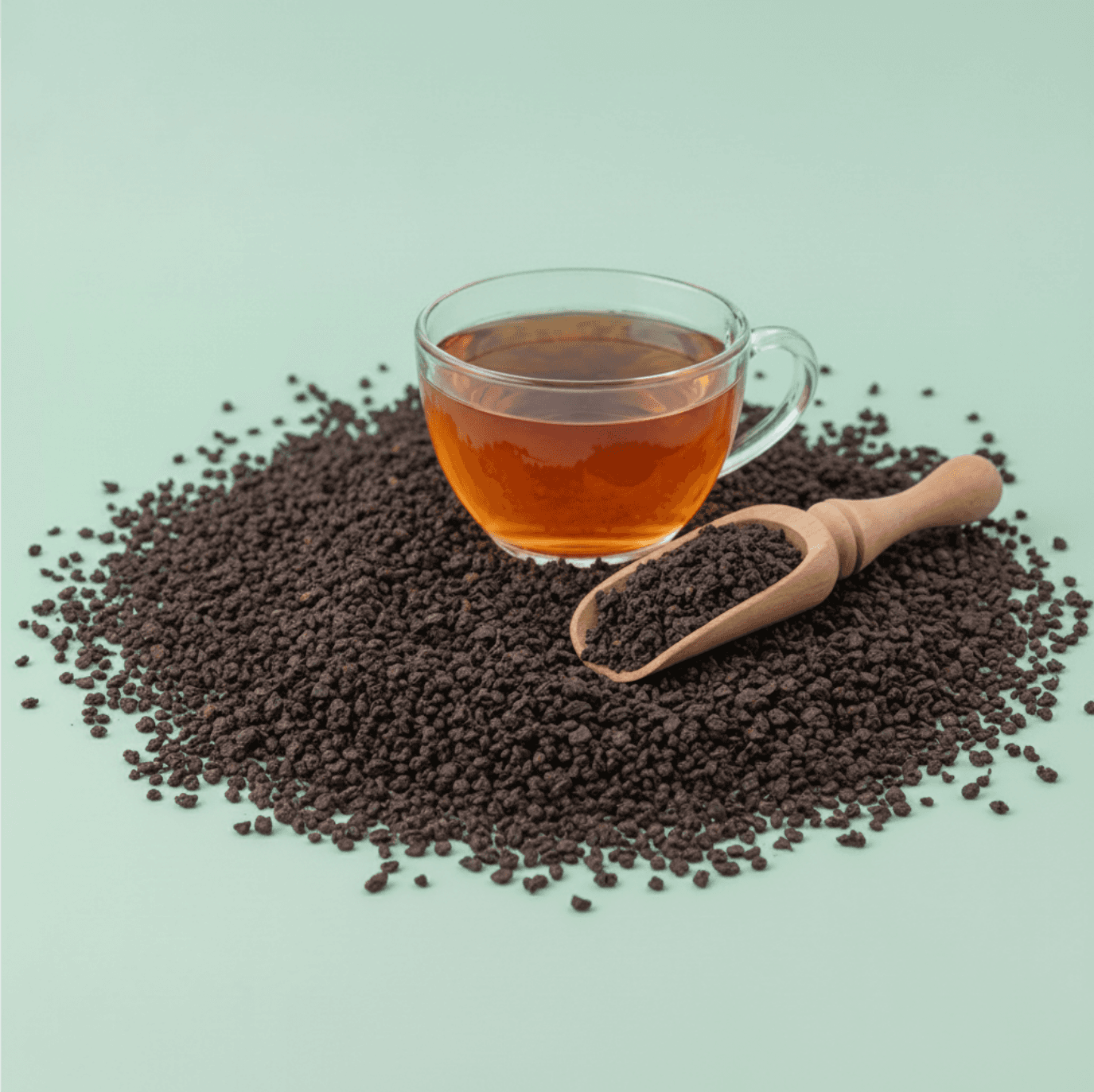 person holding clear glass mug with yellow liquid