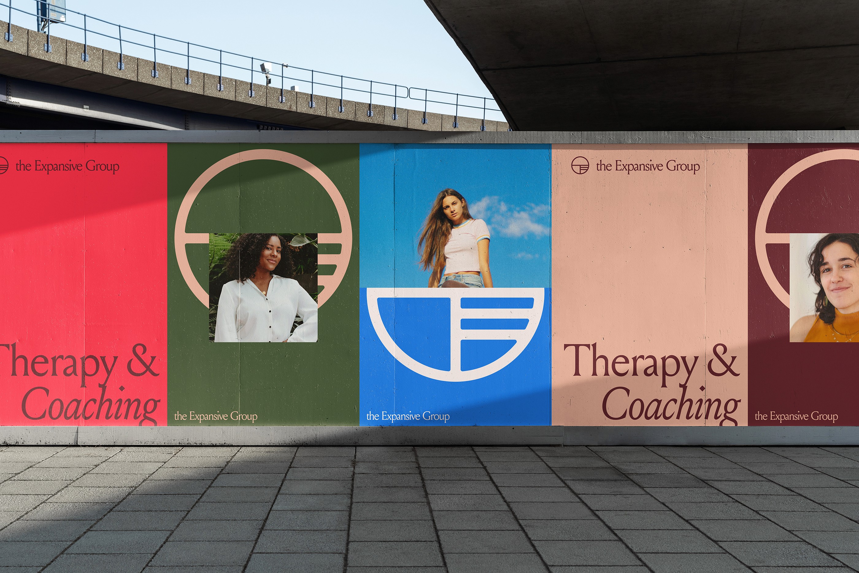 The Expansive Group branding demonstrated on a long billboard under an overpass.