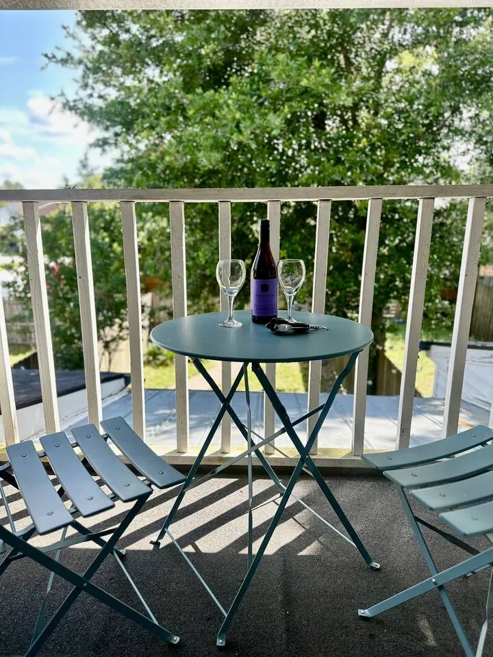 Small upstairs balcony with a bistro table and two folding chairs