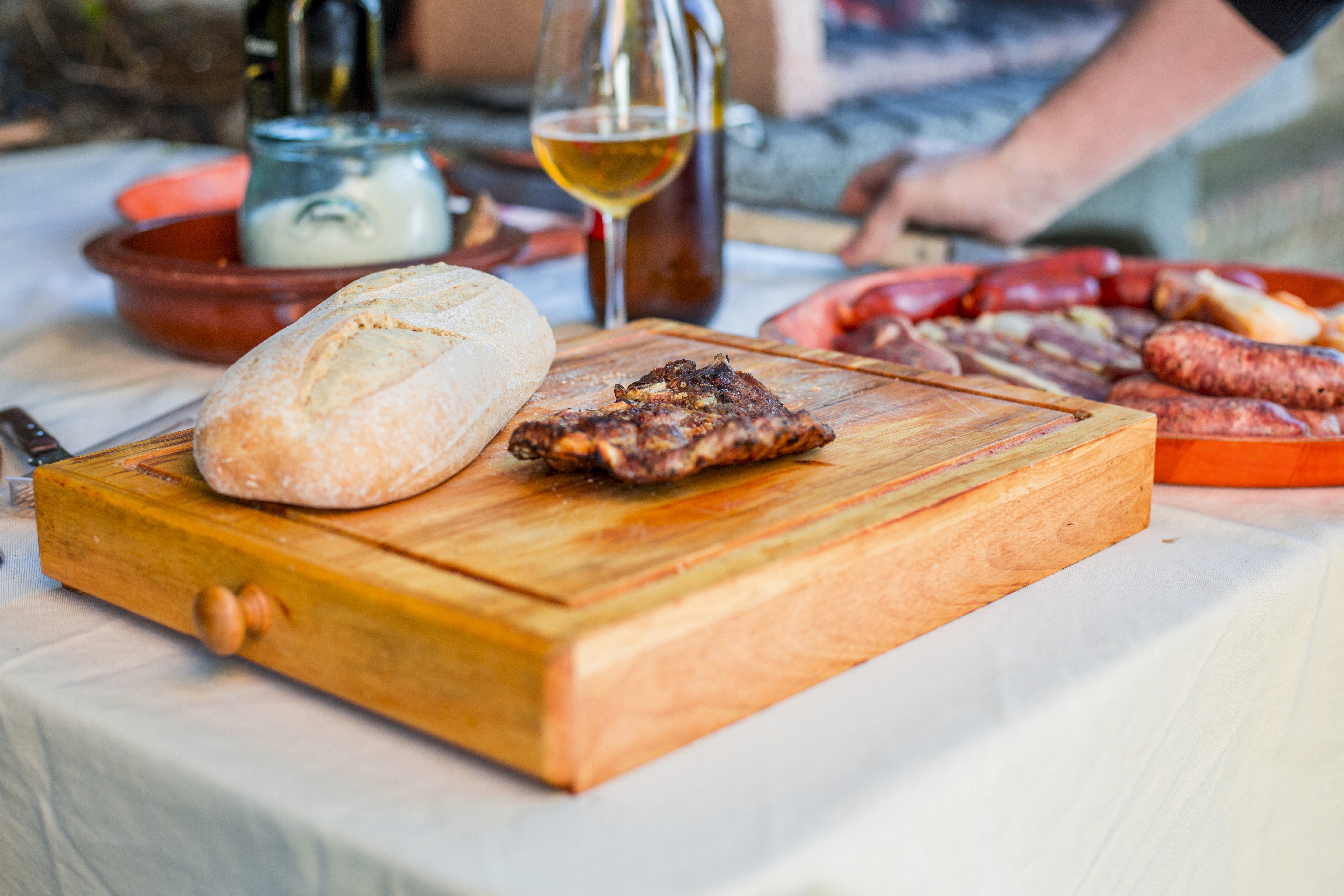 Open pizza box next to glass of wine