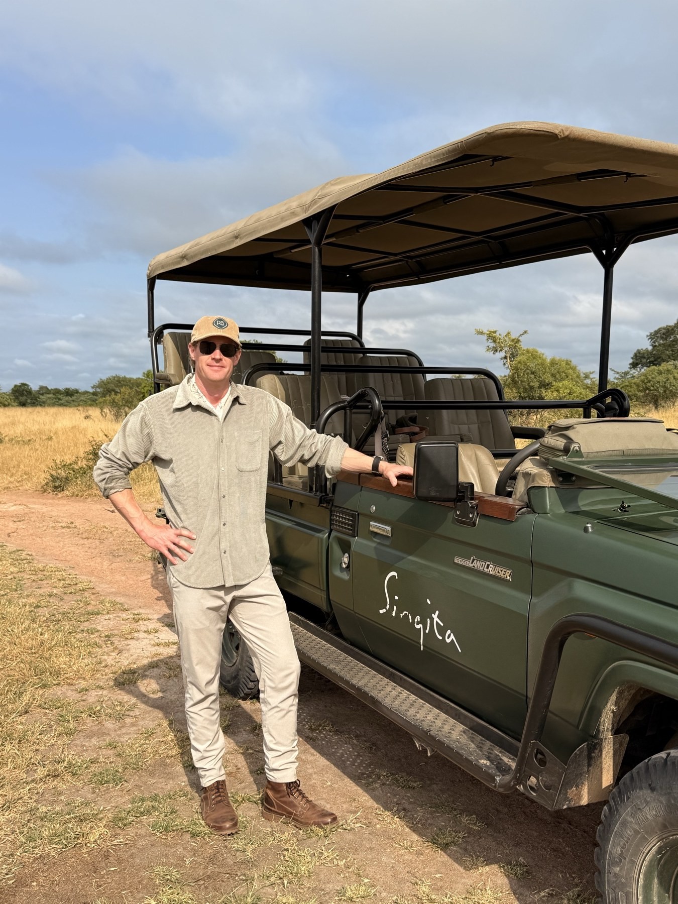 Hans Arnesen beside a Singita Land Cruiser on safari