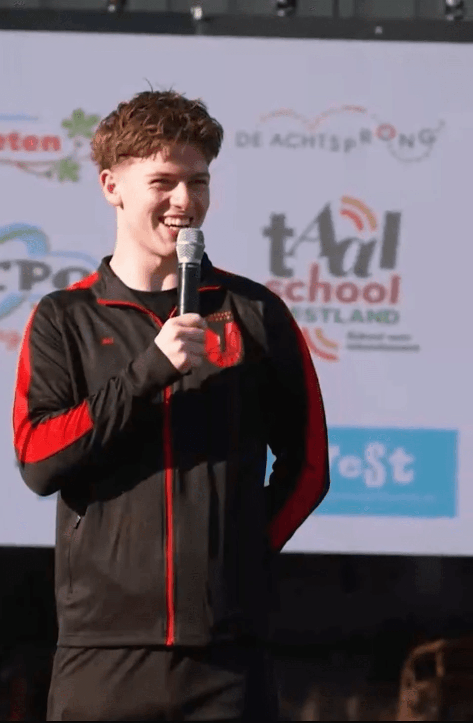 A man standing confidently in front of a gym mural with gym-goers in the background. Quote: “I gained 12 pounds of lean muscle in 3 months…” – Construction Supervisor.