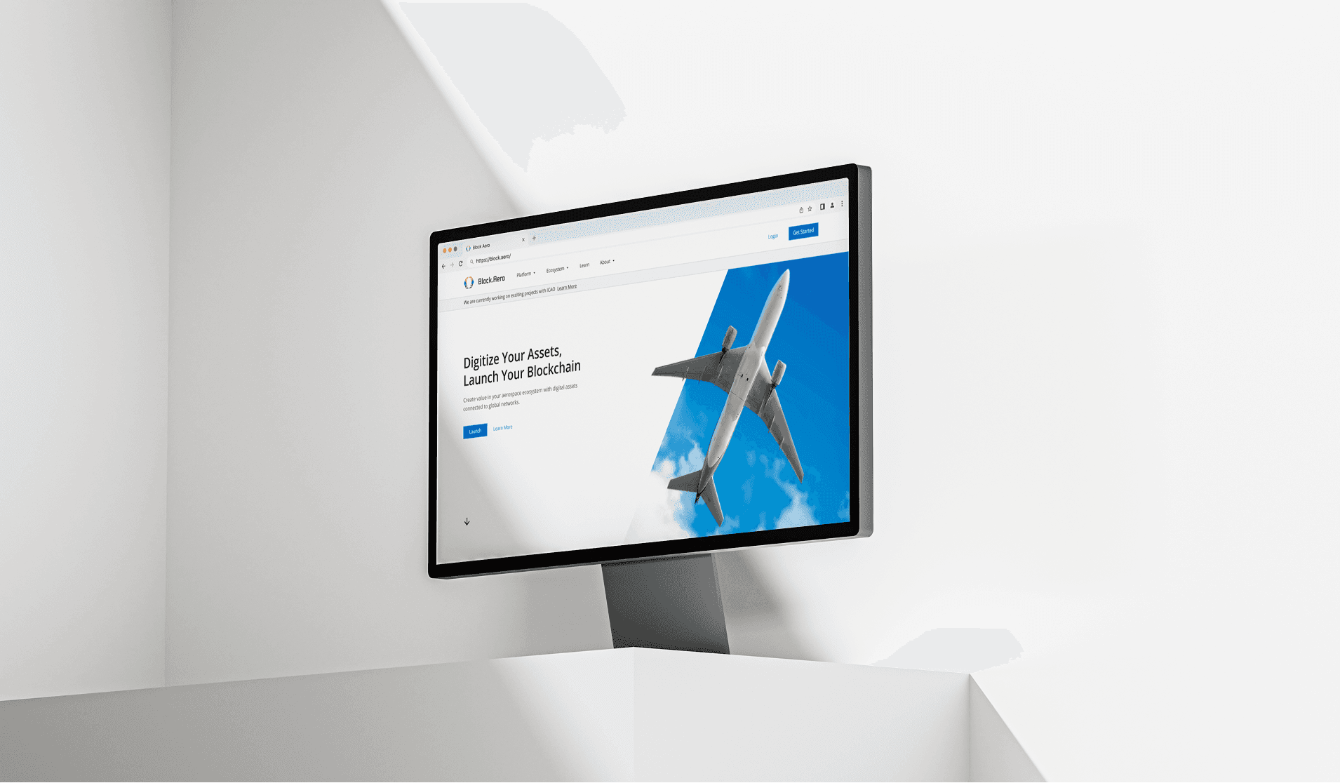 Block Aero website displayed on a desktop monitor featuring the headline Digitize Your Assets, Launch Your Blockchain with a commercial airplane background.