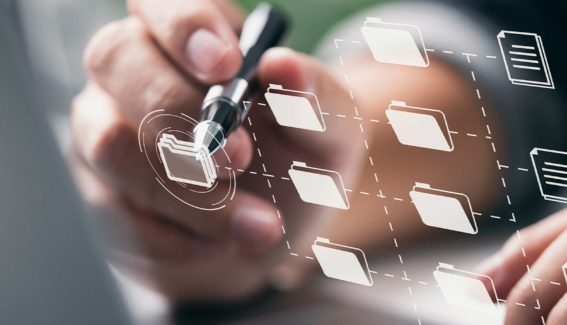 employee using pen to touch folders on screens