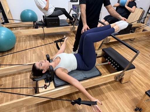 person in black leather shoes standing on gray asphalt road