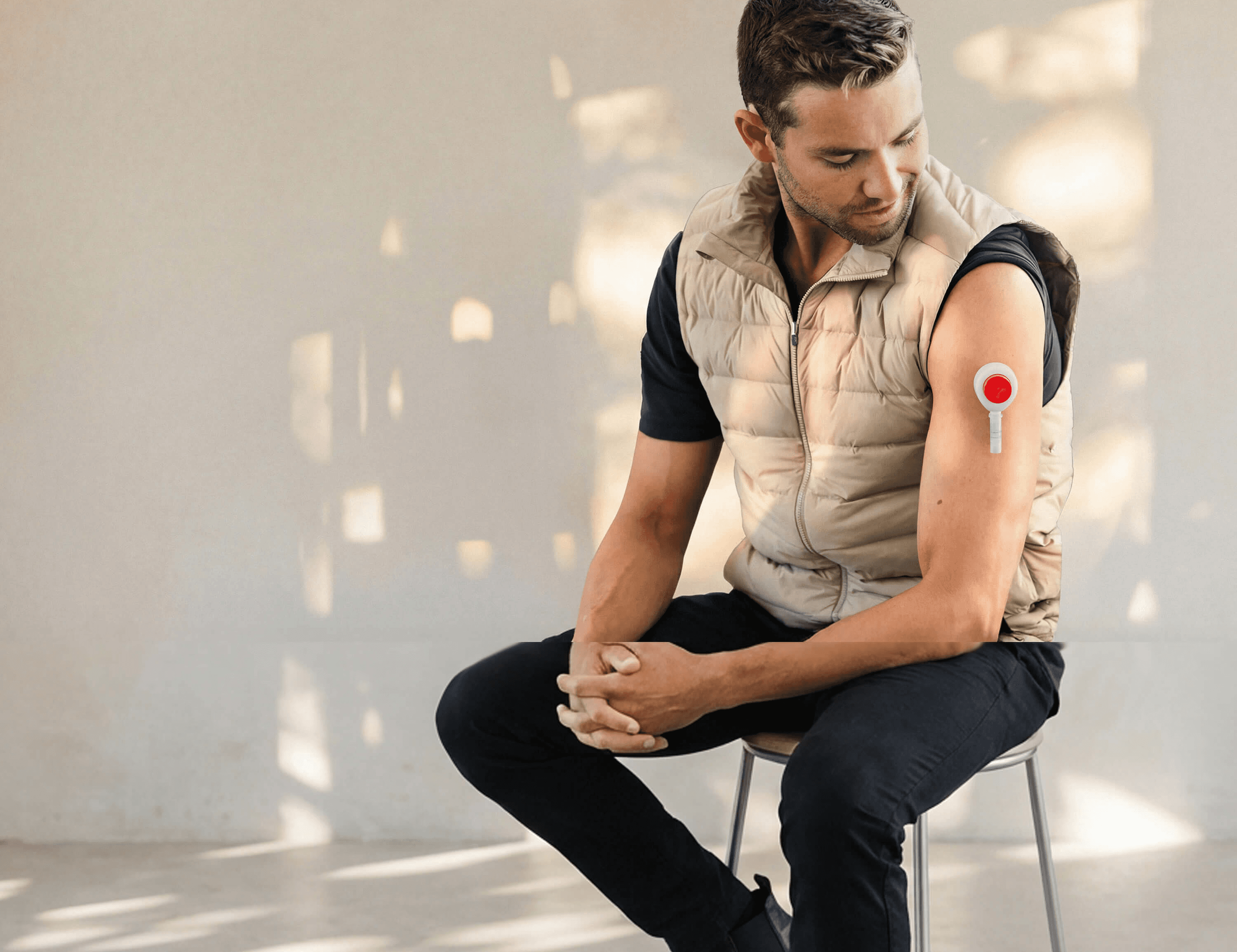 Man collecting a blood sample from his upper arm using an at-home test kit.