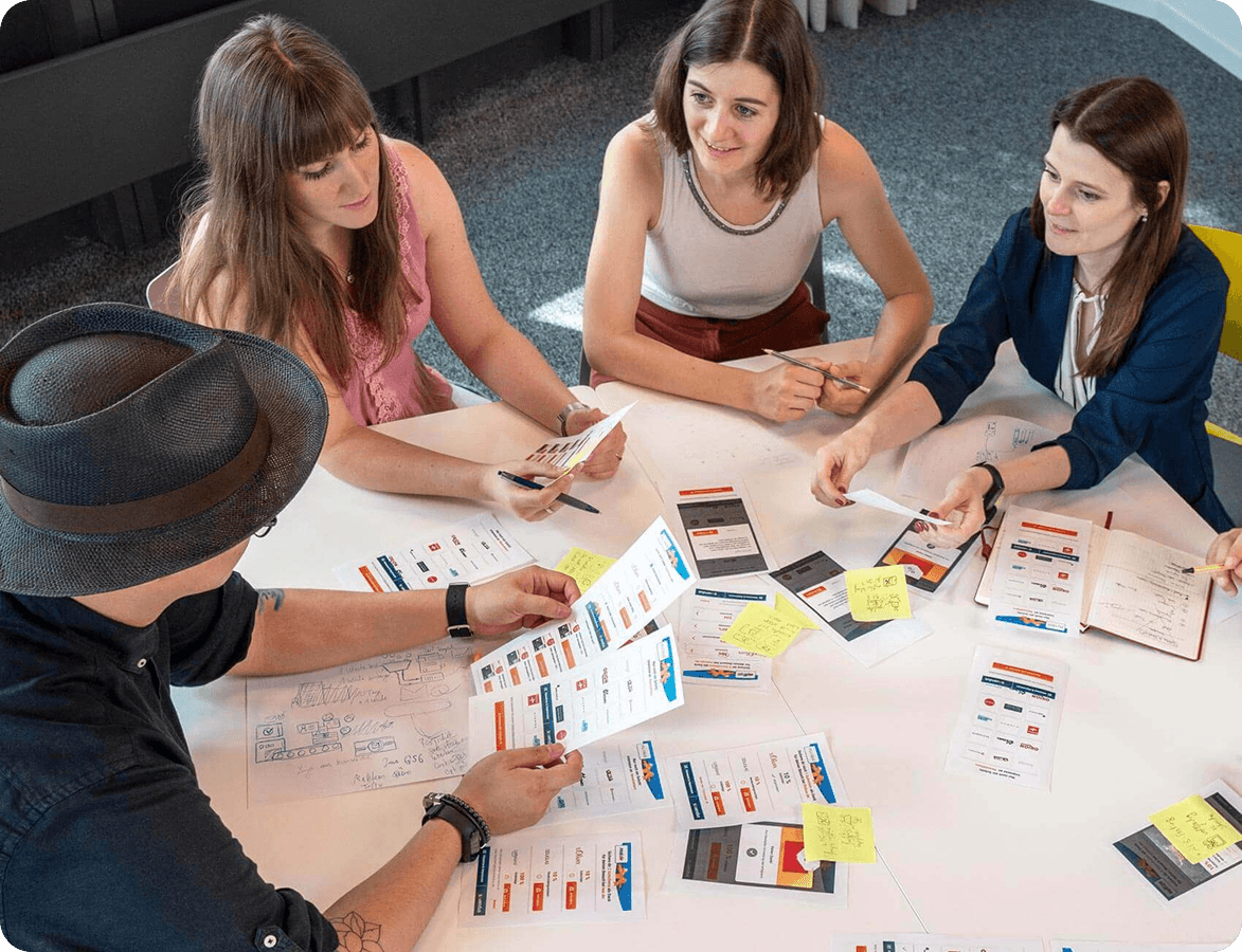 Sovendus UX team discussing screen designs at a table in the Sovendus office