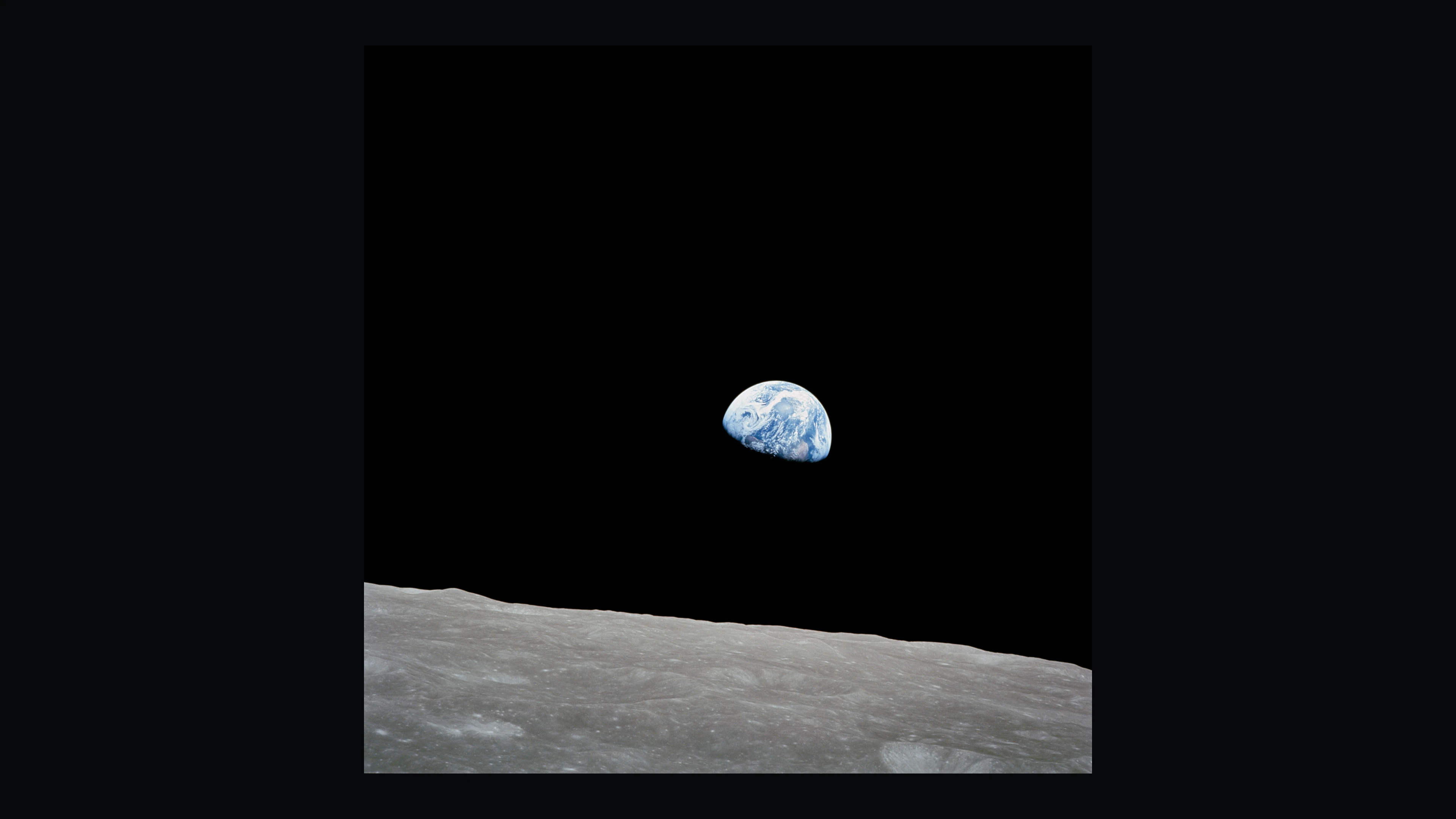 Earth rising above the Moon’s horizon in William Anders’ Apollo 8 photograph.