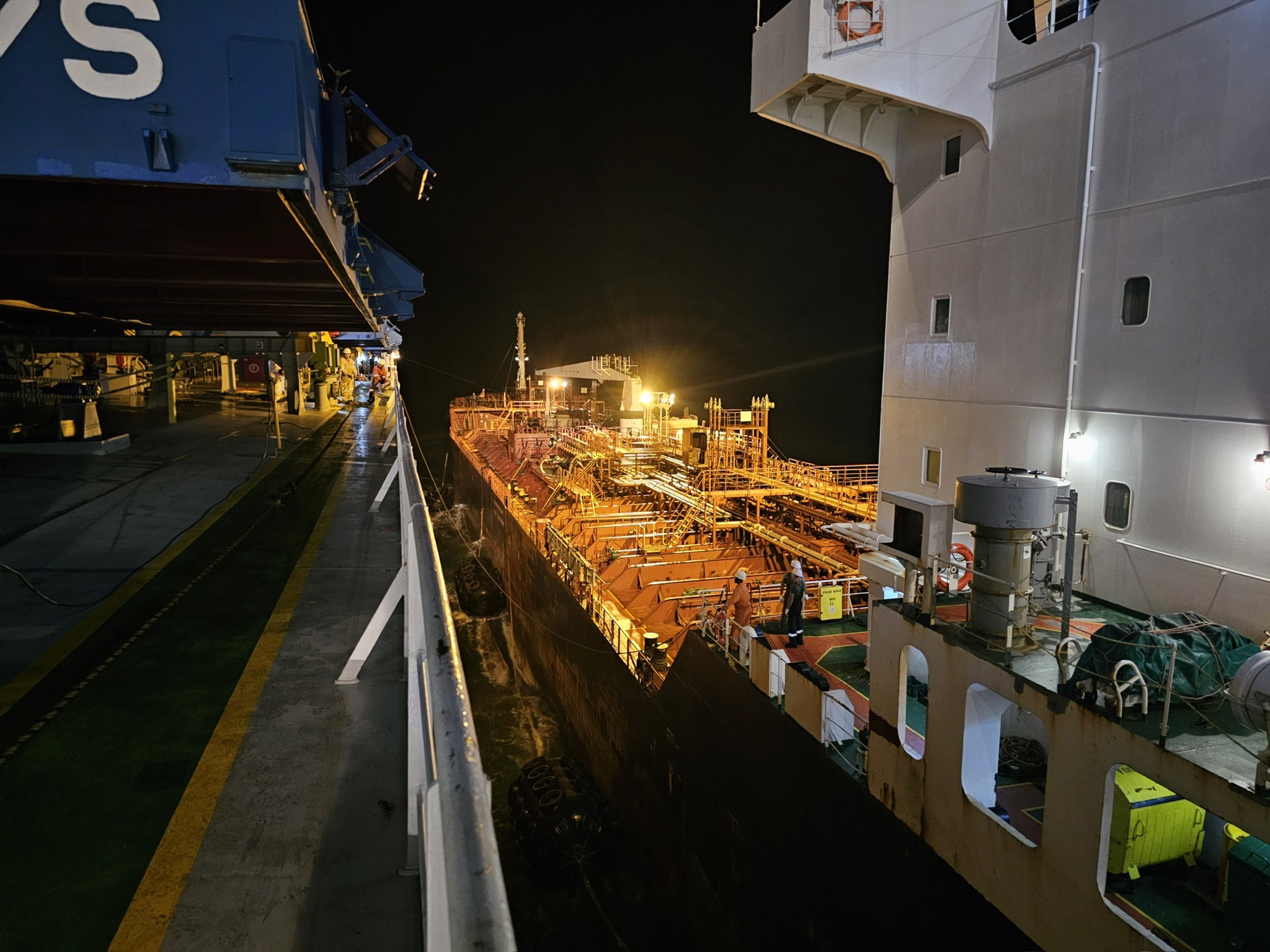 Nighttime ship-to-ship bunkering at Santos anchorage, coordinated by CARGOWARD®, as preparations begin for bunker survey attendance and custody documentation.