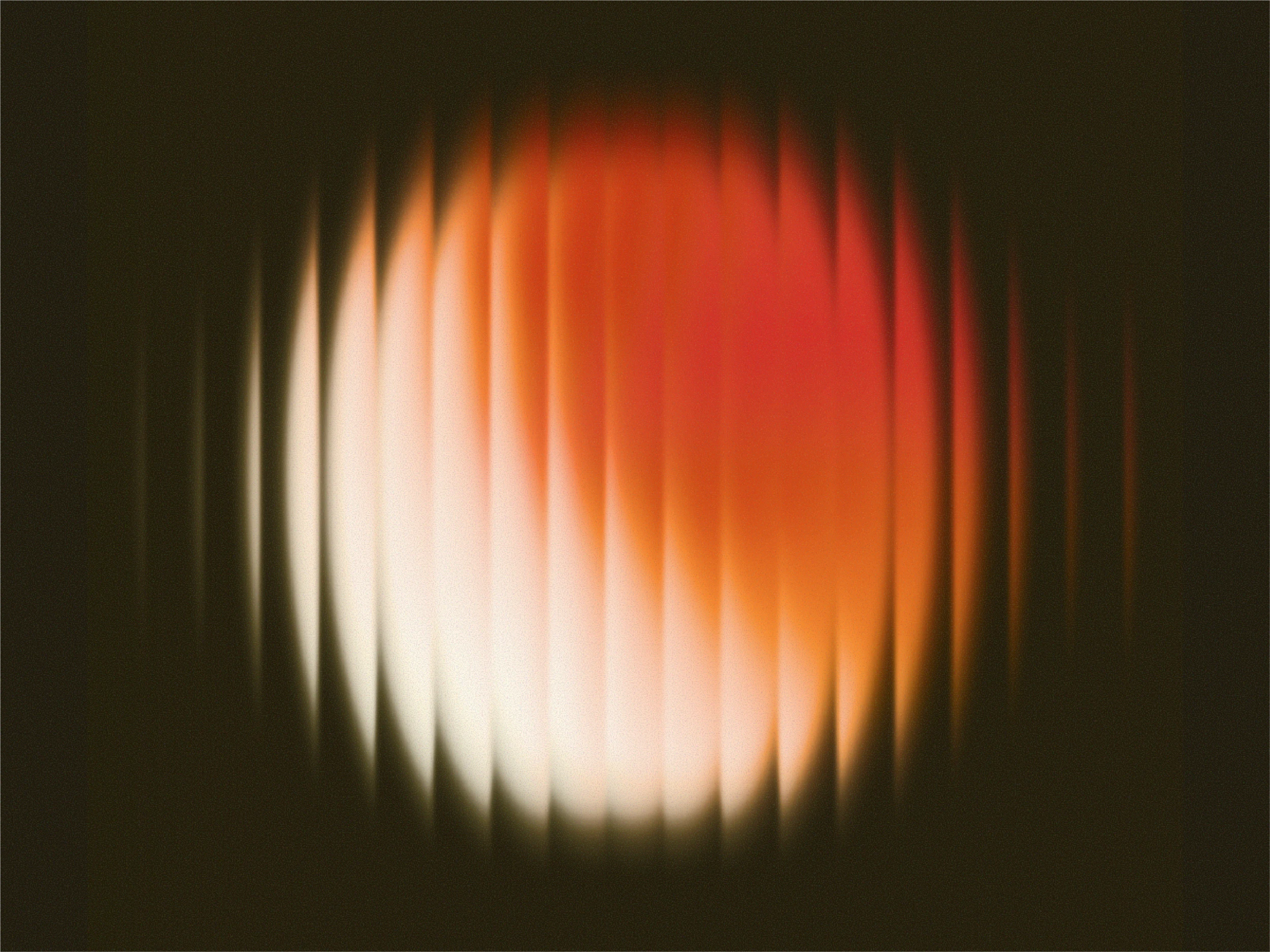 Partial solar eclipse showing a bright crescent shape with an orange glow against a dark sky.