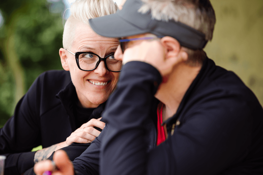 Melanie stares at Chris as Chris looks off