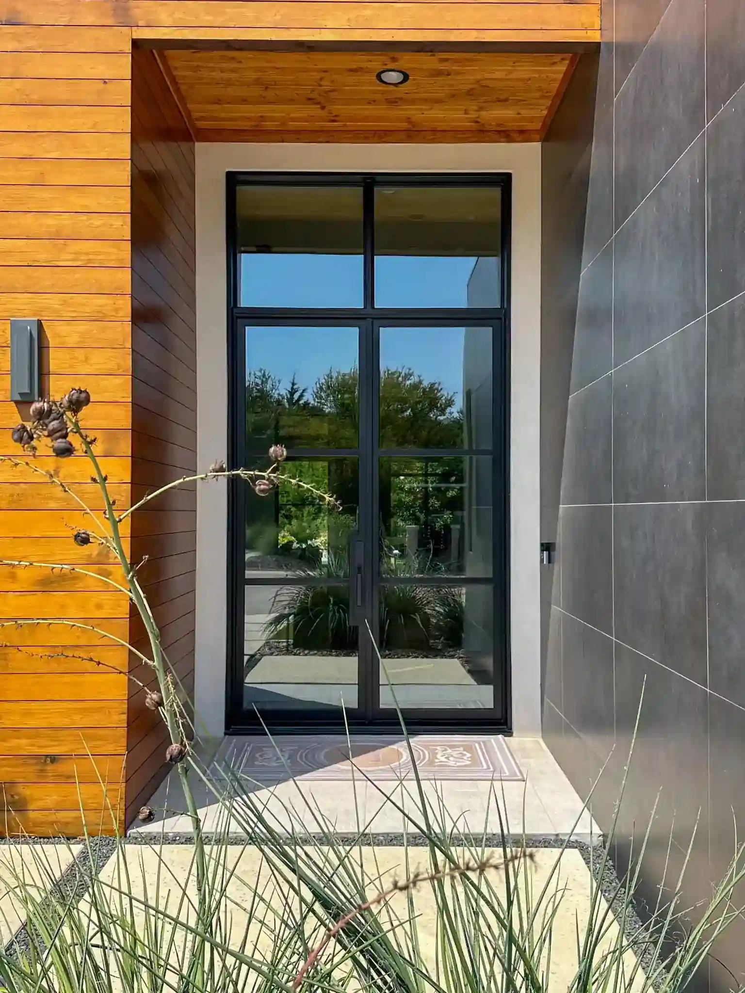 Modern low profile door with wood architecture on a Dallas-Fort Worth home