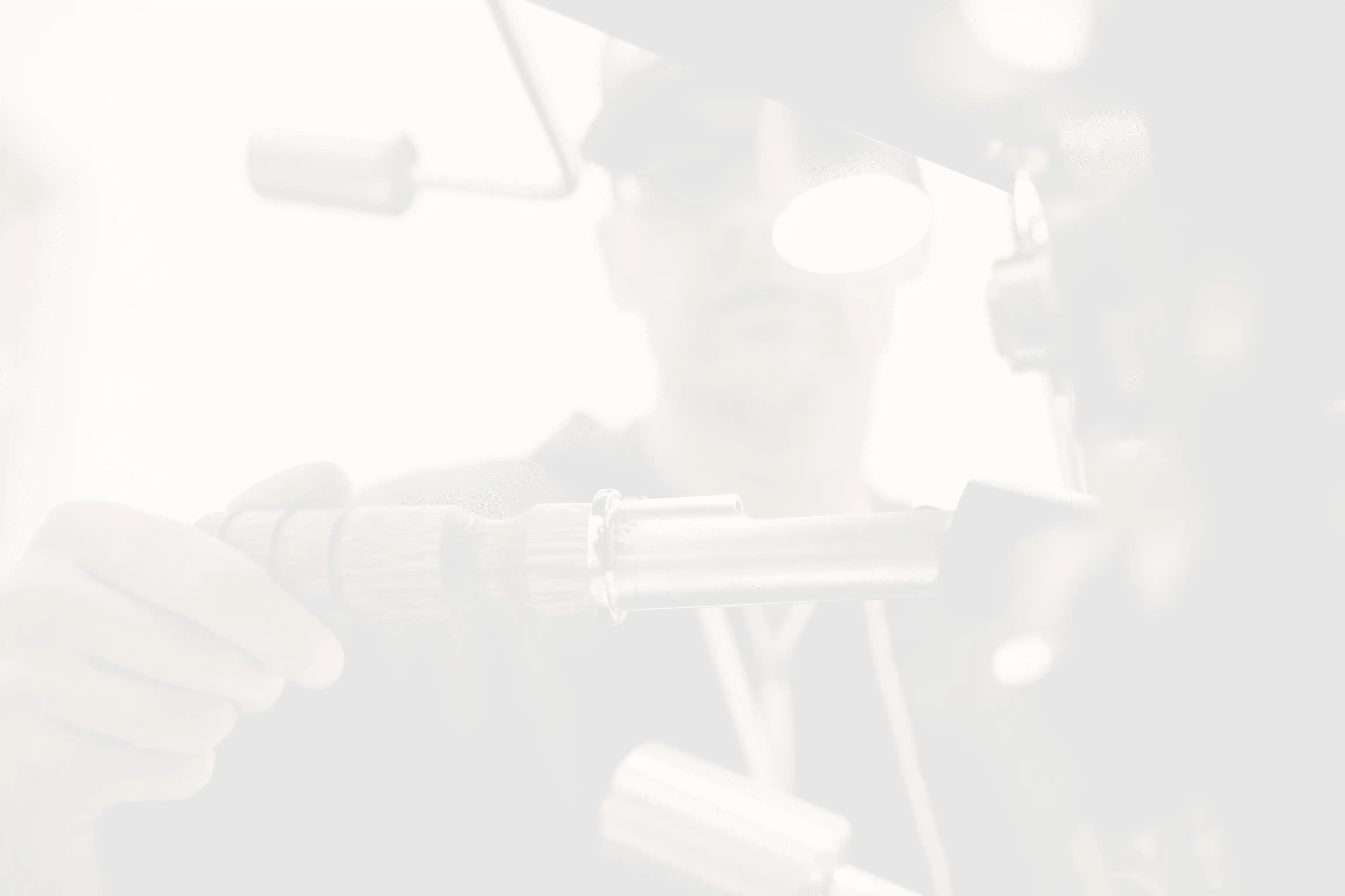 man wearing black pullover hoodie holding tool