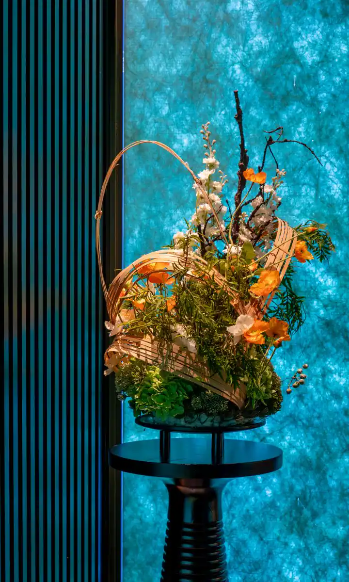 Backlit turquoise onyx wall and floral arrangement