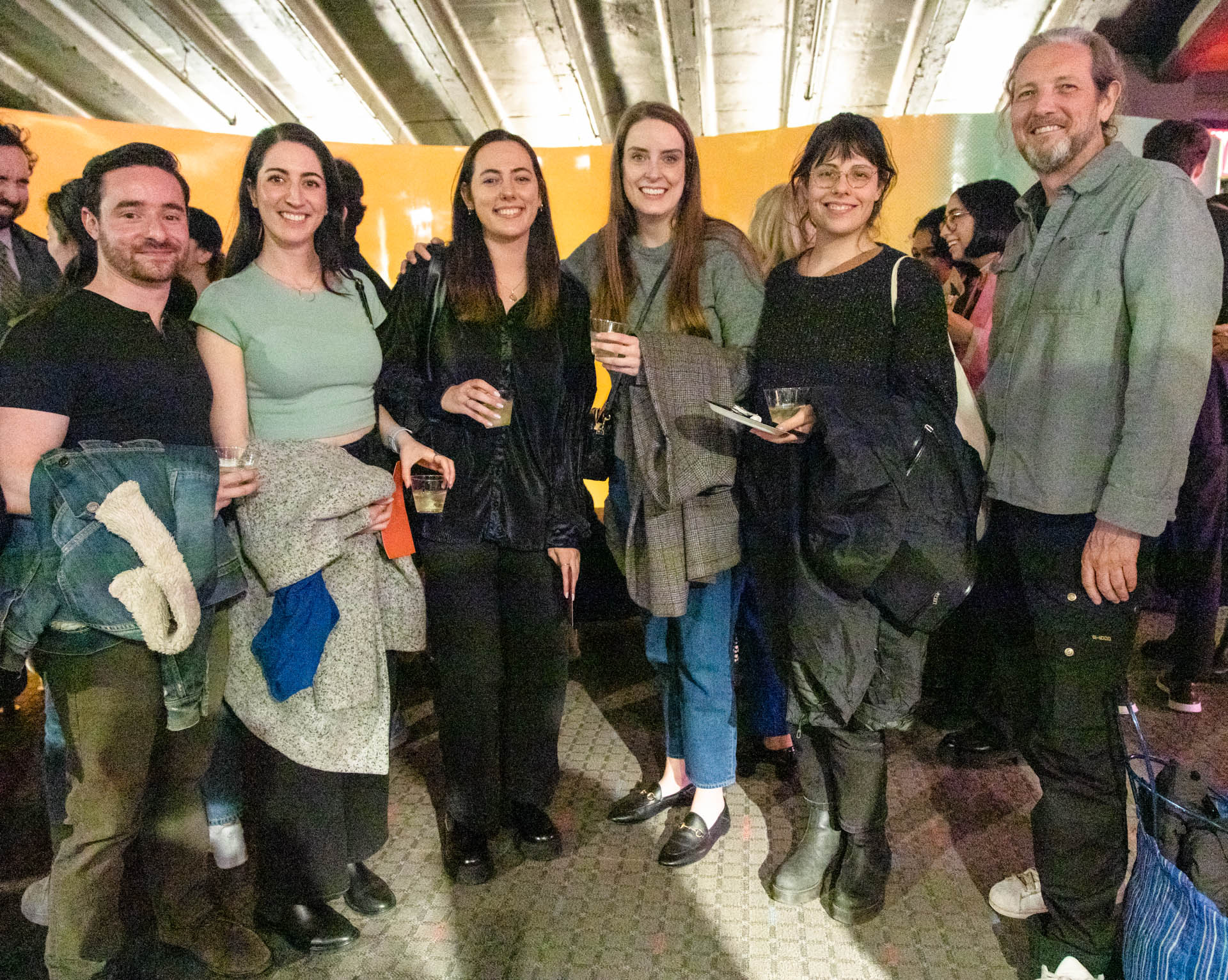 a group of students smiling for the camera in the SVA Theatre lobby after the Venture Forum