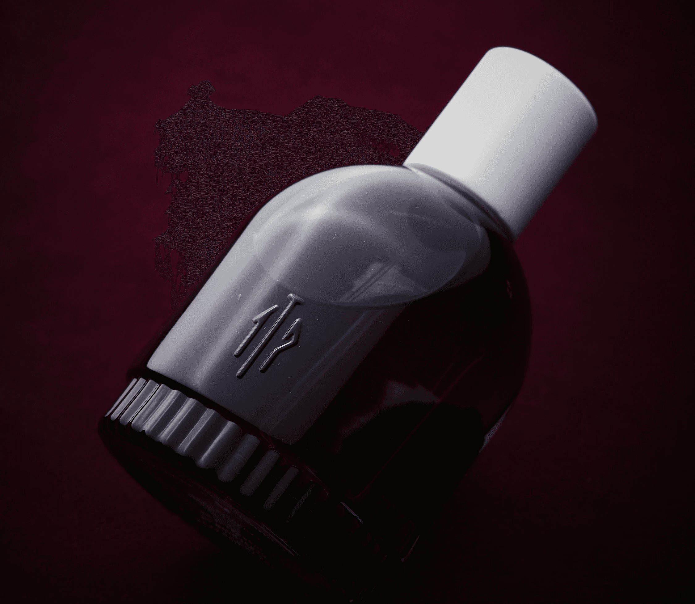 A close-up of a hand wearing multiple decorative rings against a blue background.