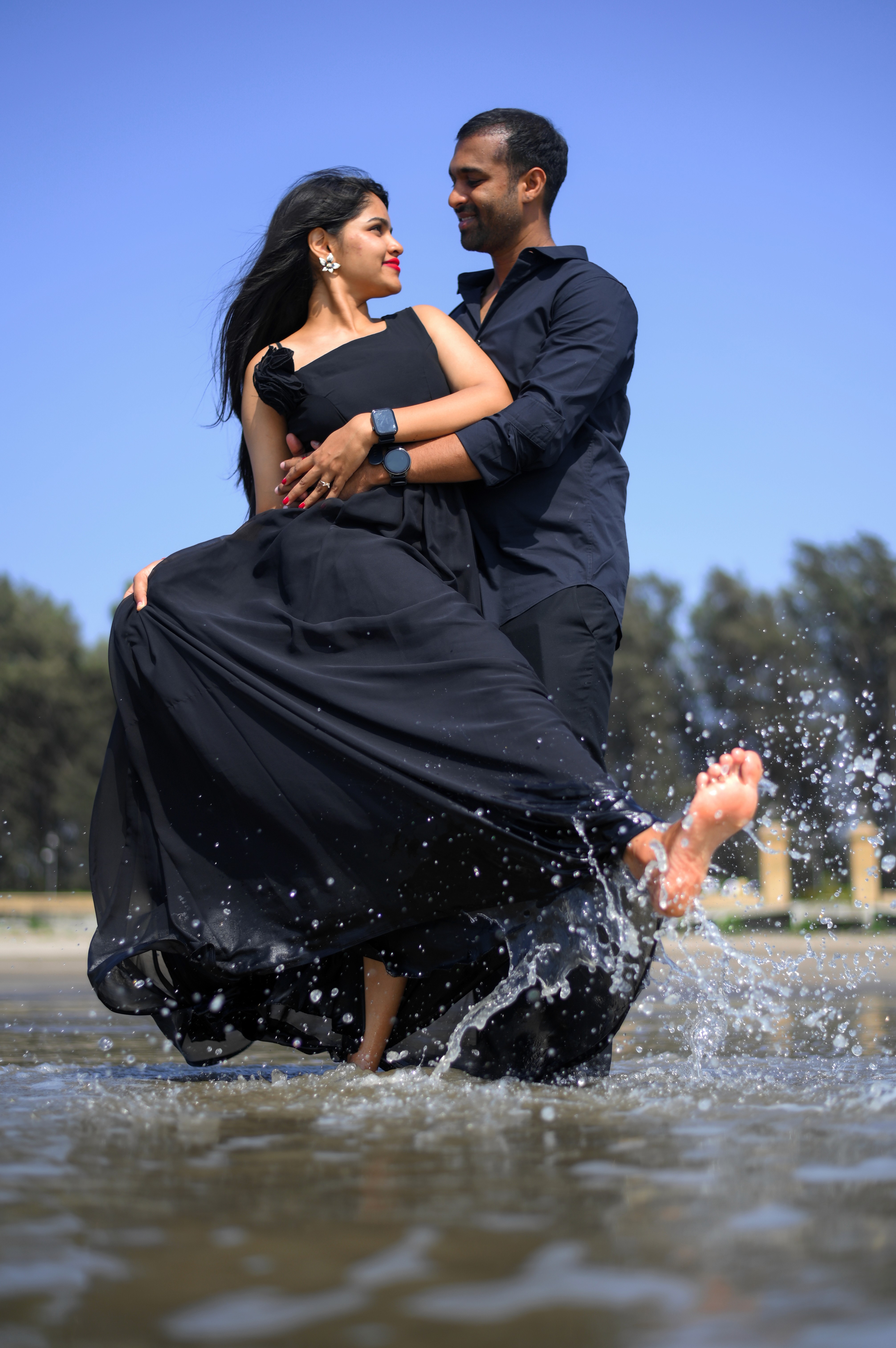 A couple stands closely in an intimate embrace.