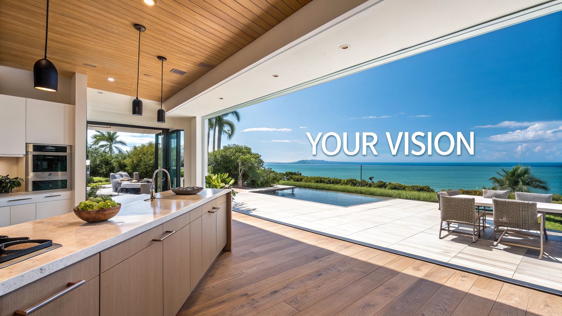 Modern kitchen with open sliding doors revealing an ocean view, infinity pool, and outdoor dining area.