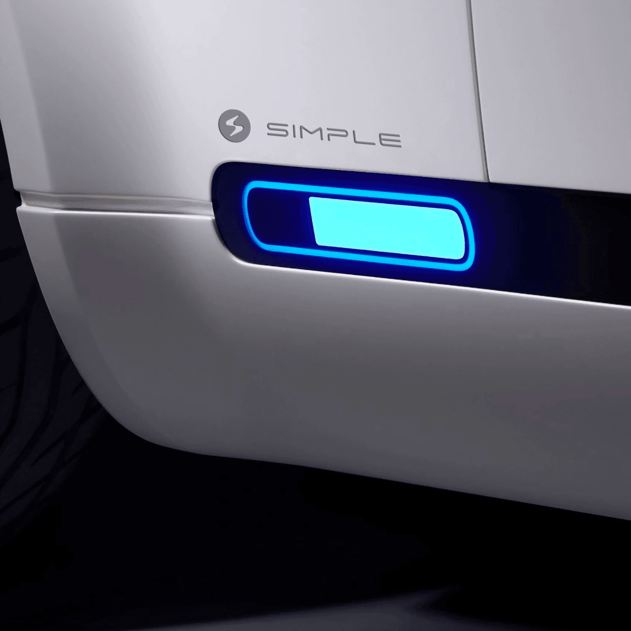 Rear detail of electric scooter charging port with illuminated Simple Energy logo