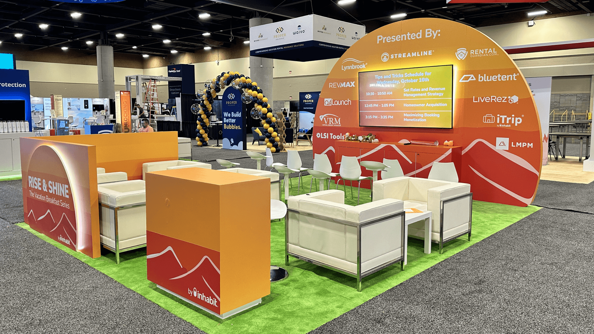 Rise and Shine by Inhabitat VRMA 2024 20x20 lounge booth with seating areas, screen presentation, branded counters, and open conversation space