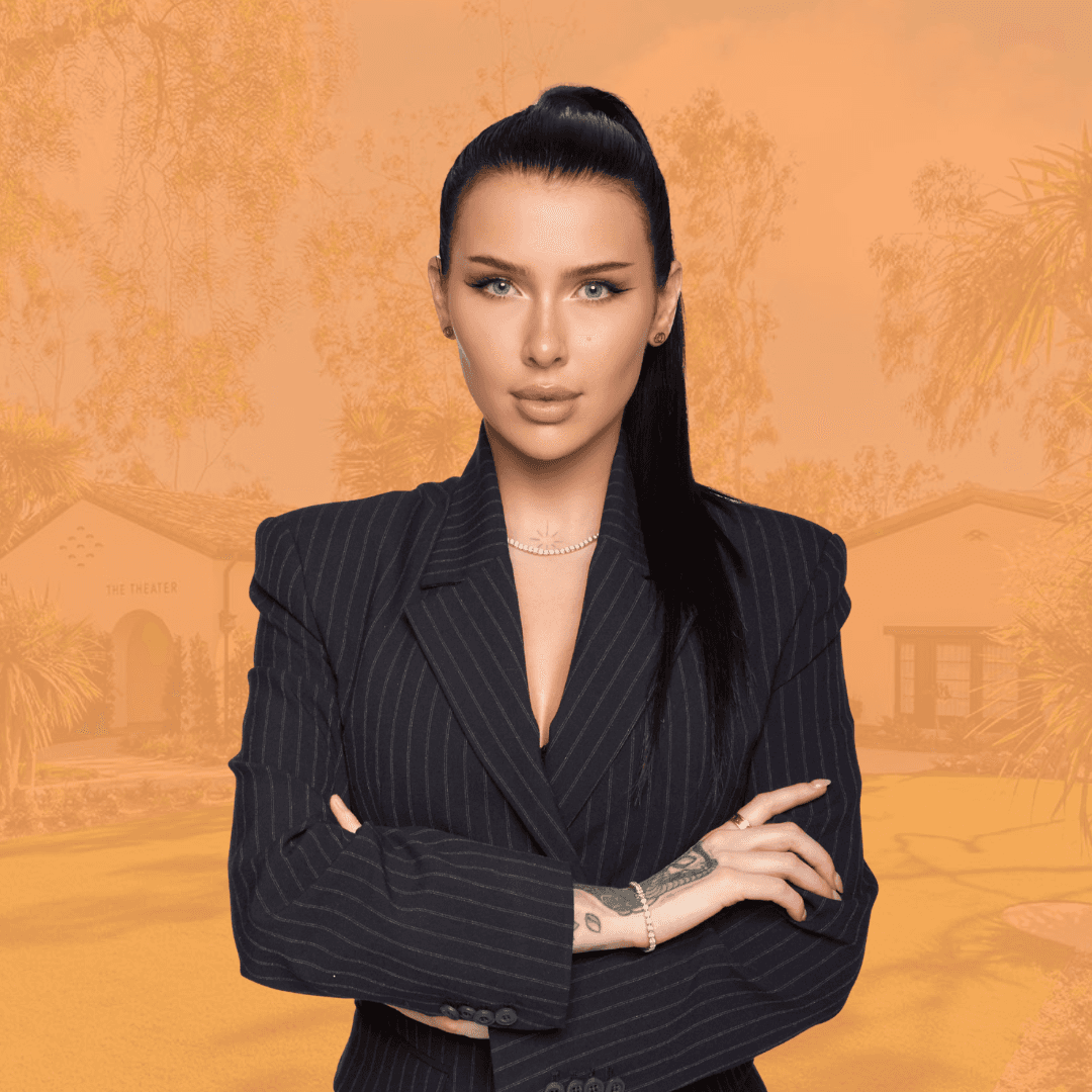 Confident man standing in a greenhouse surrounded by lush green plants, wearing a beige shirt and neutral-toned outfit.