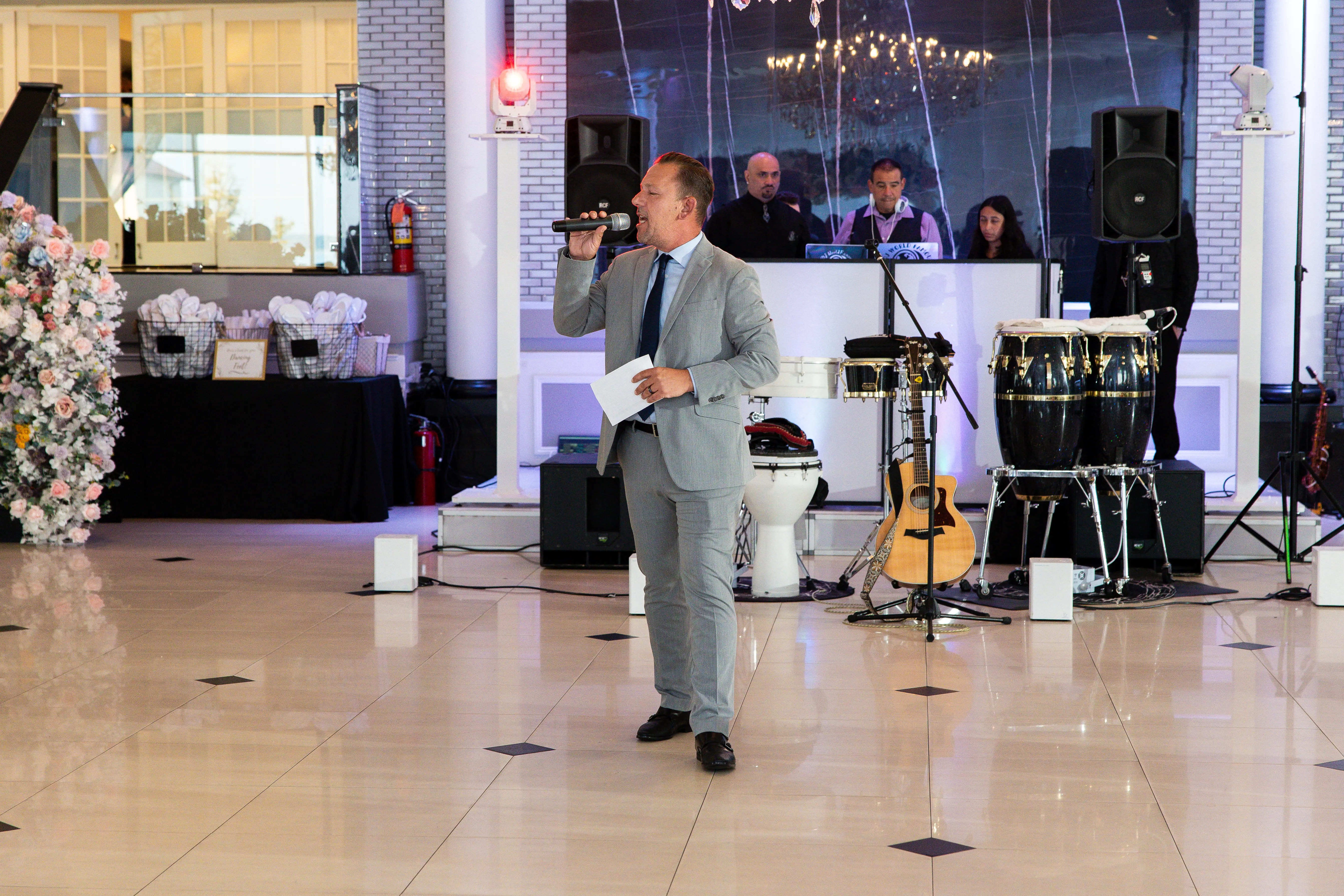 Wedding MC making announcements and guiding reception timeline with microphone