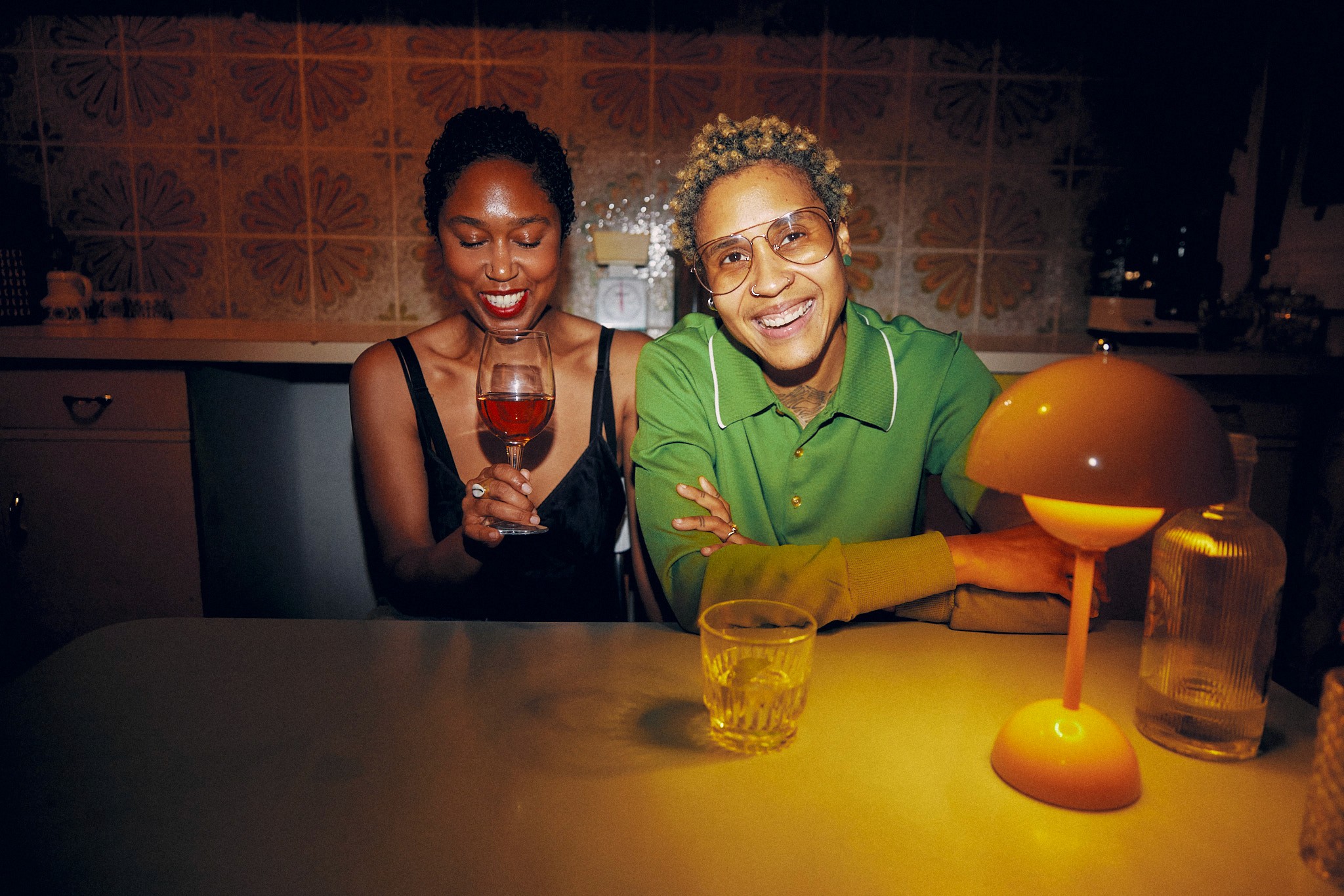 A tan sighthound stands in a grassy field.