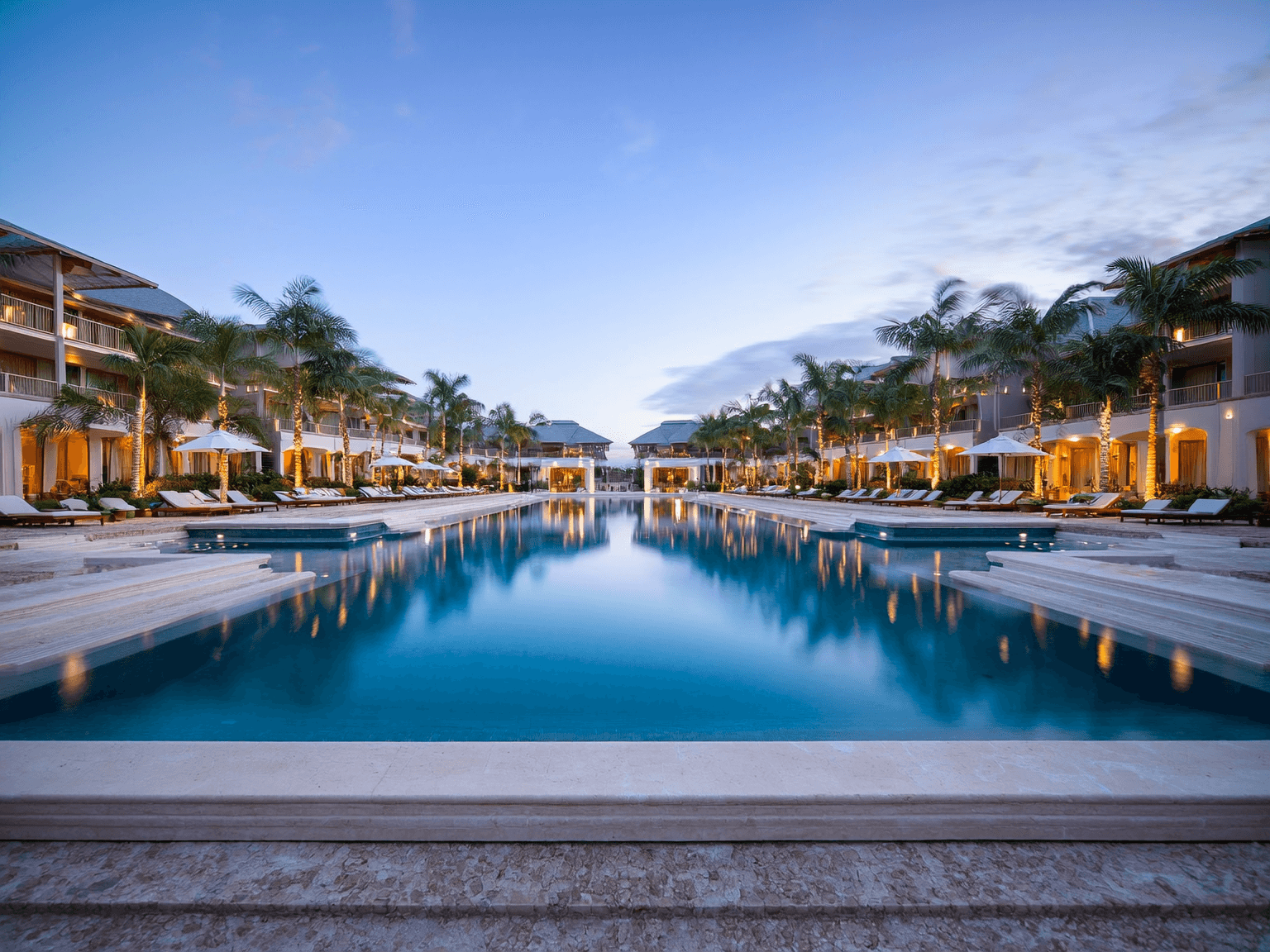 Luxury Florida clubhouse pool area at sunset, perfectly maintained.